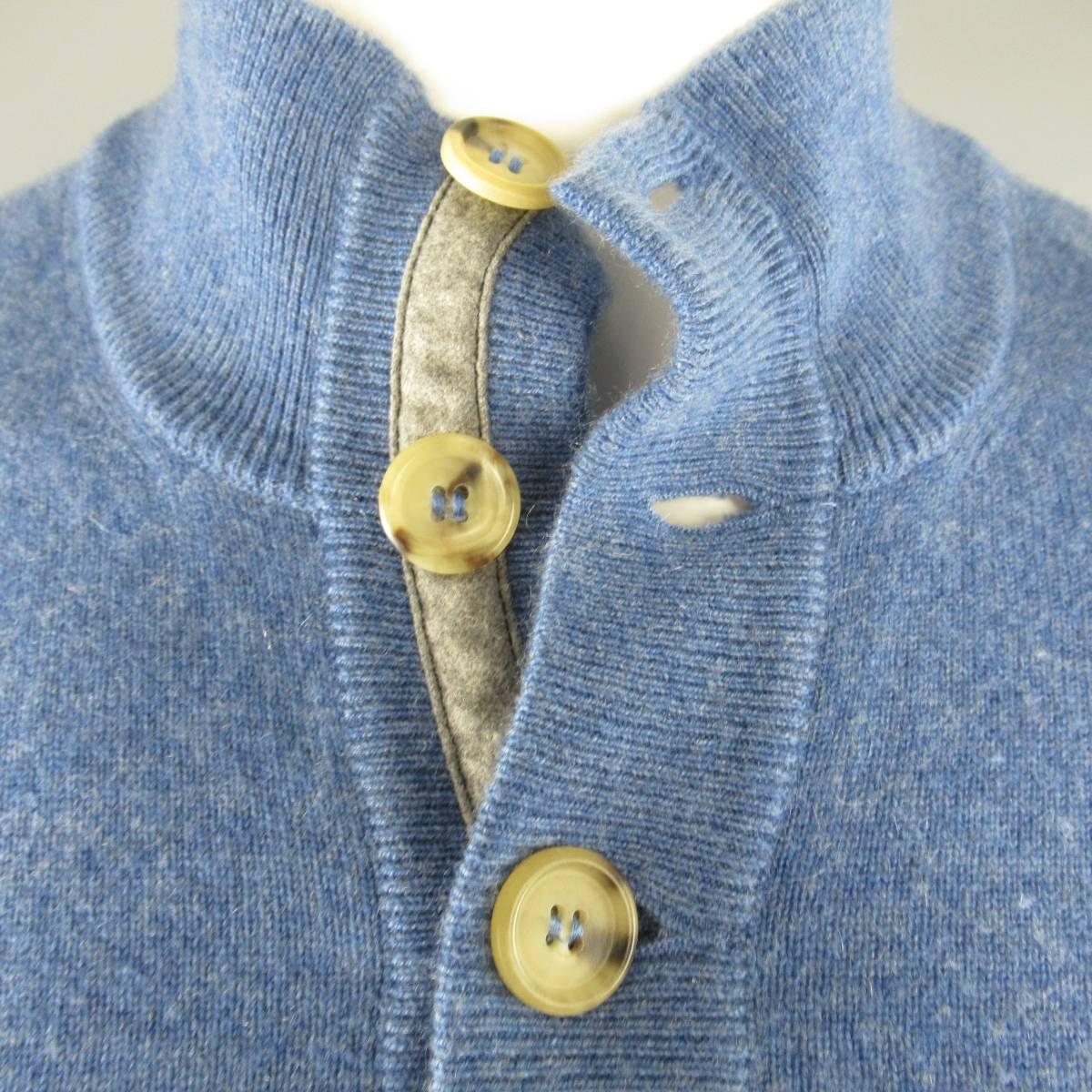 BRUNELLO CUCINELLI Pullover consists of cashmere material in a powder blue color tone. Designed with a high rib-collar, 4-button front in tortoise shell tone. Detailed rib cuffs and hem. Missing tag. (As-Is)  Made in Italy.
 
Good Pre-Owned