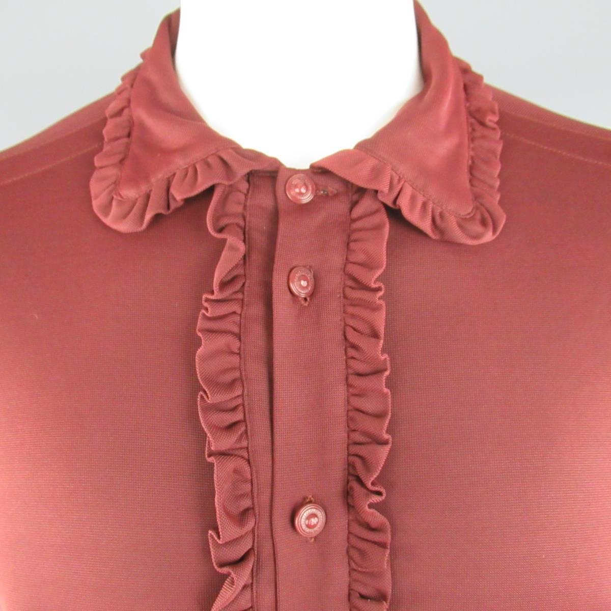 Vintage VERSUS by GIANNI VERSACE shirt comes in a soft polimide fabric featuring a pointed collar, monochromatic tone engraved buttons, and ruffled trim throughout. Made in Italy.
 
Excellent Pre-Owned Condition.
Marked: (tag removed)

