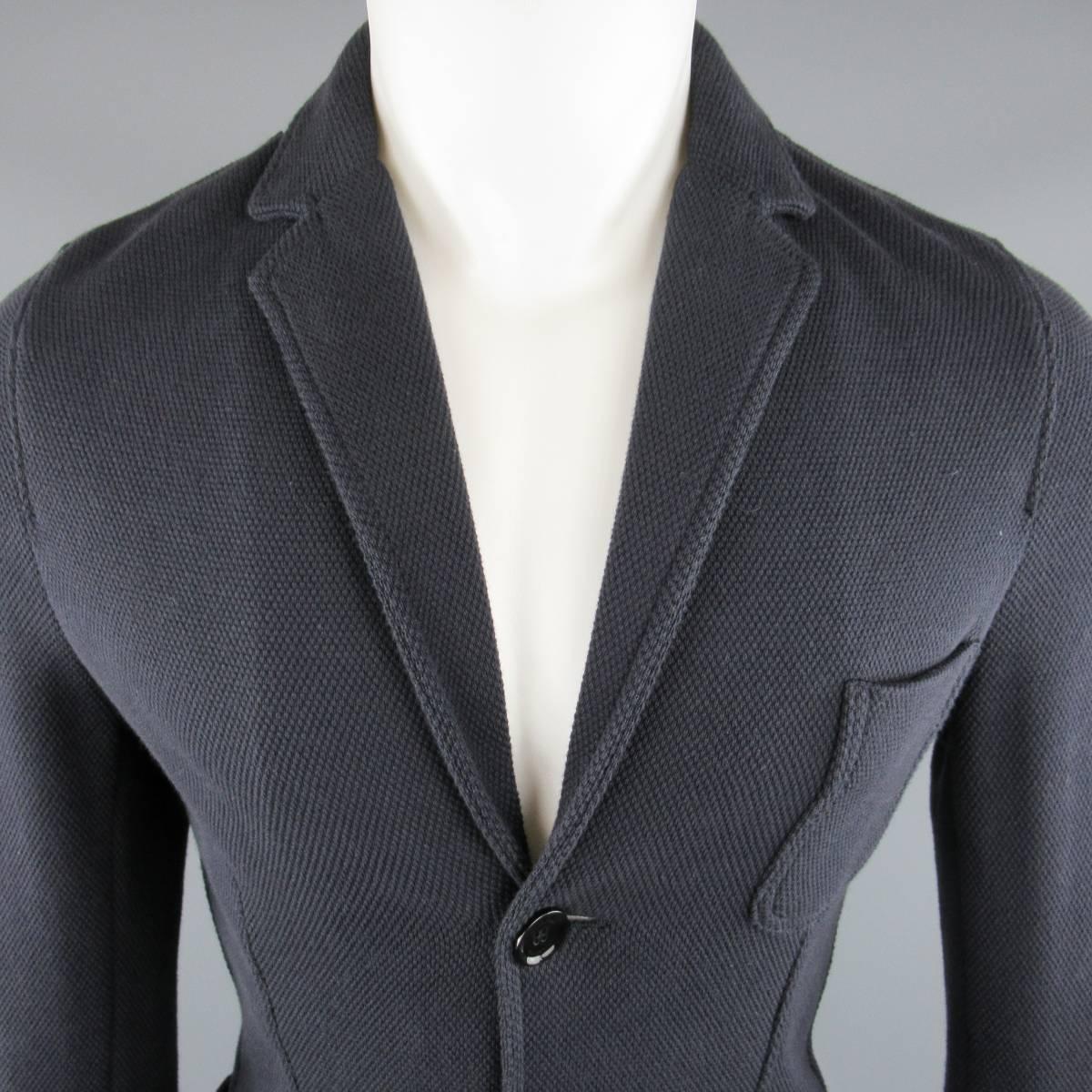 VALENTINO Sport Coat consists of cotton blend material in a navy color tone. Designed in a notch lapel, 2-button front with bottom patch pockets and top pocket. Unconstructed lining. Made in Italy.
 
Good Pre-Owned Condition 
Marked Size: S
