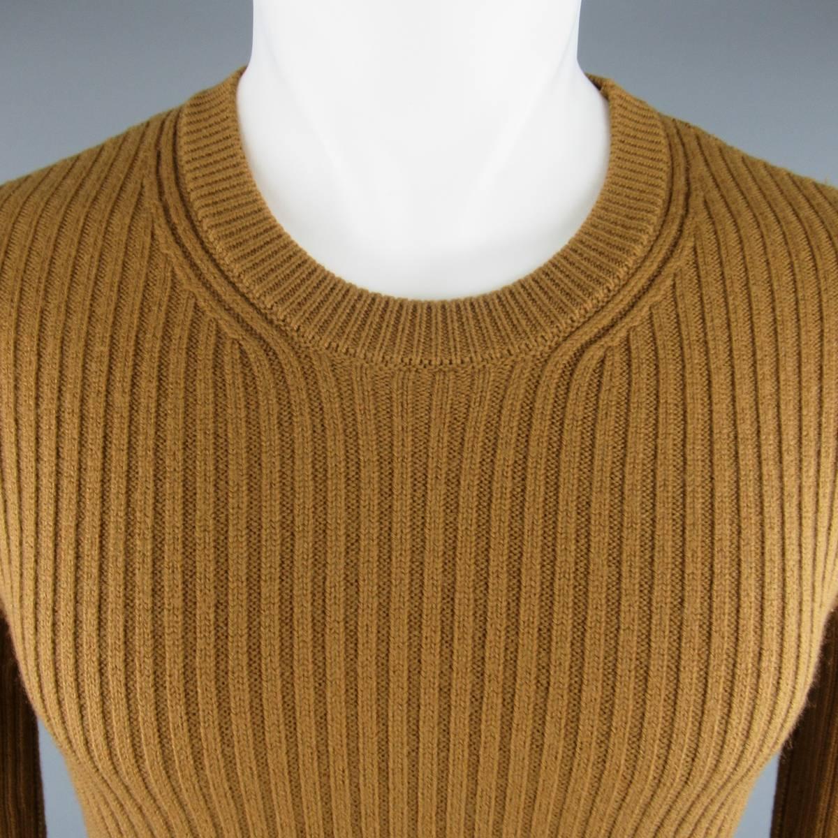 DOLCE & GABBANA Sweater consists of wool material in a tan color tone. Designed with a crew-neck collar and rib patterning throughout body. Made in Italy.
 
Good Pre-Owned Condition 
Marked Size: 48
 
Measurements
 
Shoulder: 16 in.
Chest: 36