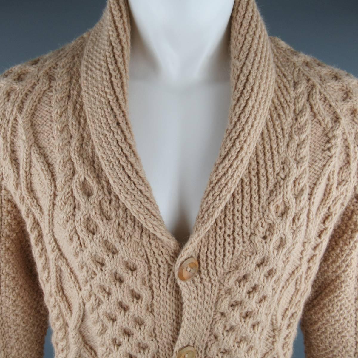 INVERALLAN Cardigan consists of wool material in a cream/khaki color tone. Designed in double/cable knit, shawl collar with a 5-button up front. Rib cuff and hem.
Patch pockets. Pure wool . Made in Scotland.
 
Good Pre-Owned Condition
