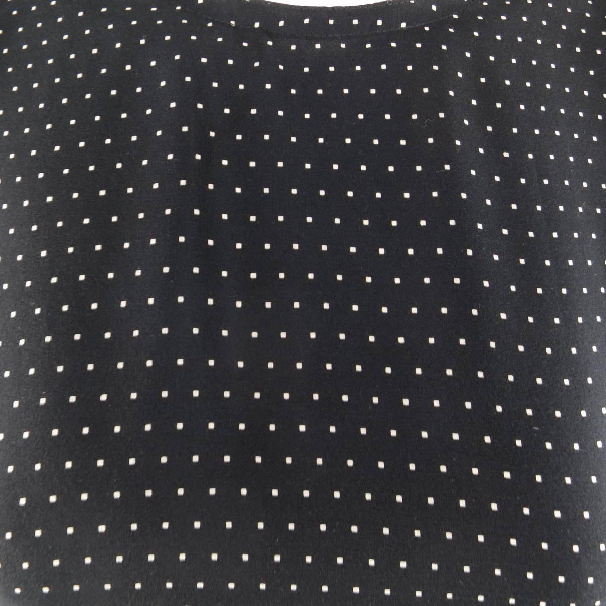 Vintage 1980's GIANNI VERSACE sleeveless blouse in a light weight black silk with cream square polka dot patter and crew neckline. Made in Italy.
 
Excellent Pre-Owned Condition.
Marked: IT 42
 
Measurements:
 
Shoulder: 14.5 in.
Bust: 38