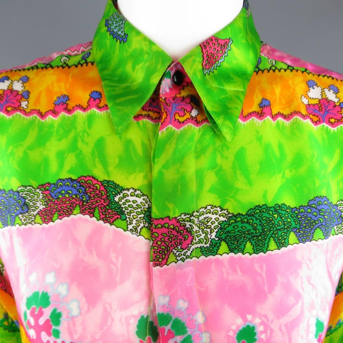 Vintage 1990's GIANNI VERSACE blouse comes in multi color silk with an all over abstract stripe print with hues of green, yellow gold, and pink featuring a pointed collar, oversized fit, and hidden placket closure. Made in Italy.
 
Excellent
