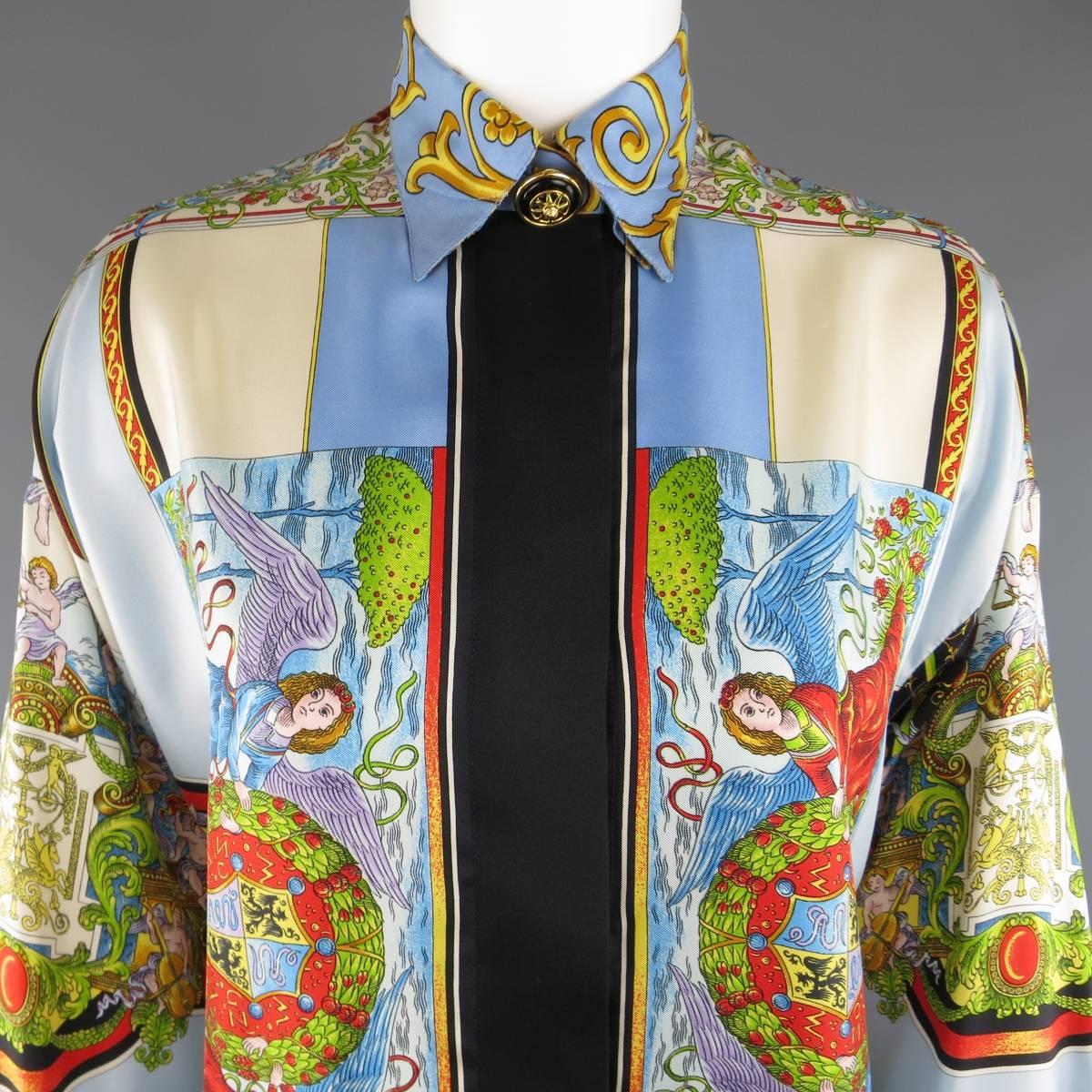 Vintage 1990's GIANNI VERSACE Couture blouse comes in a light sky blue silk twill with all over multicolor angels and crests print featuring a pointed, boroque print collar, hidden placket button up closure, and French cuffs with black and gold tone