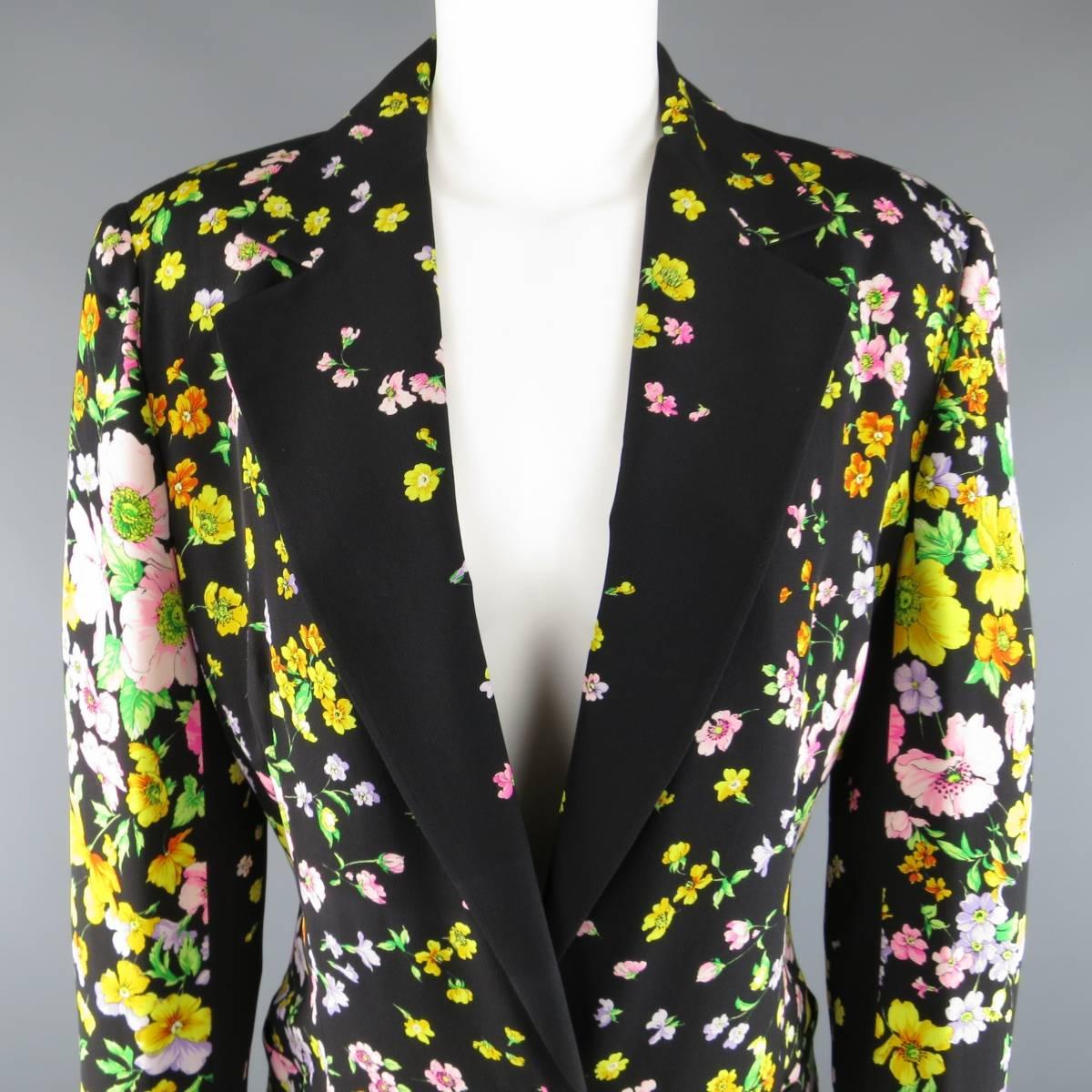 This fabulous vintage 1990's GIANNI VERSACE COUTURE blazer comes in a light weight black with all over multi-color summer floral print and features a pointed notch lapel, half lined interior, single black and gold tone Medusa head button closure and