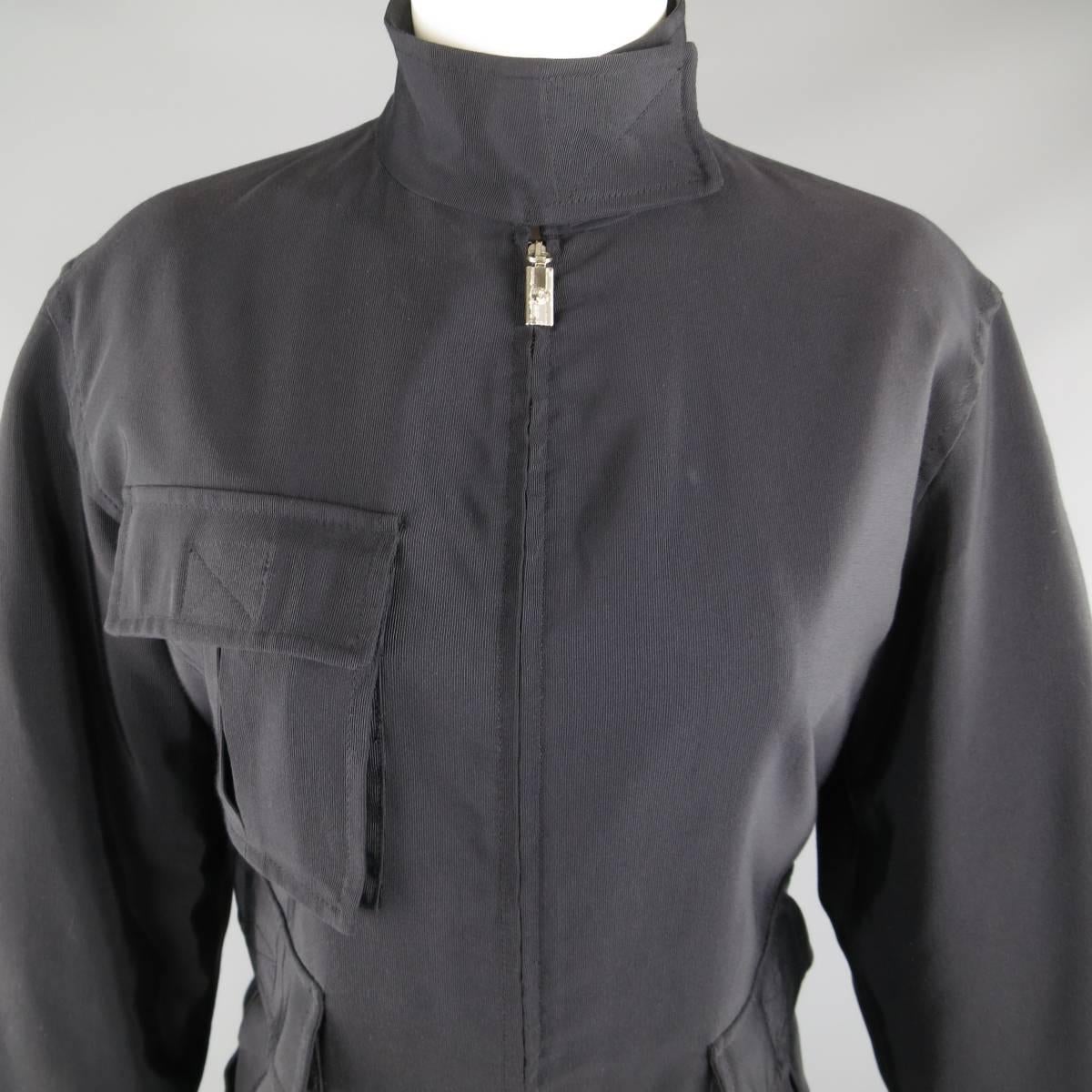 Vintage 1990's GIANNI VERSACE military style jacket comes in a black cotton rayon twill and features a high collar with velcro closure, zip front with silver tone logo tab, and triple patch flap pockets with asymmetrical hem. Wear on tab. As-Is.