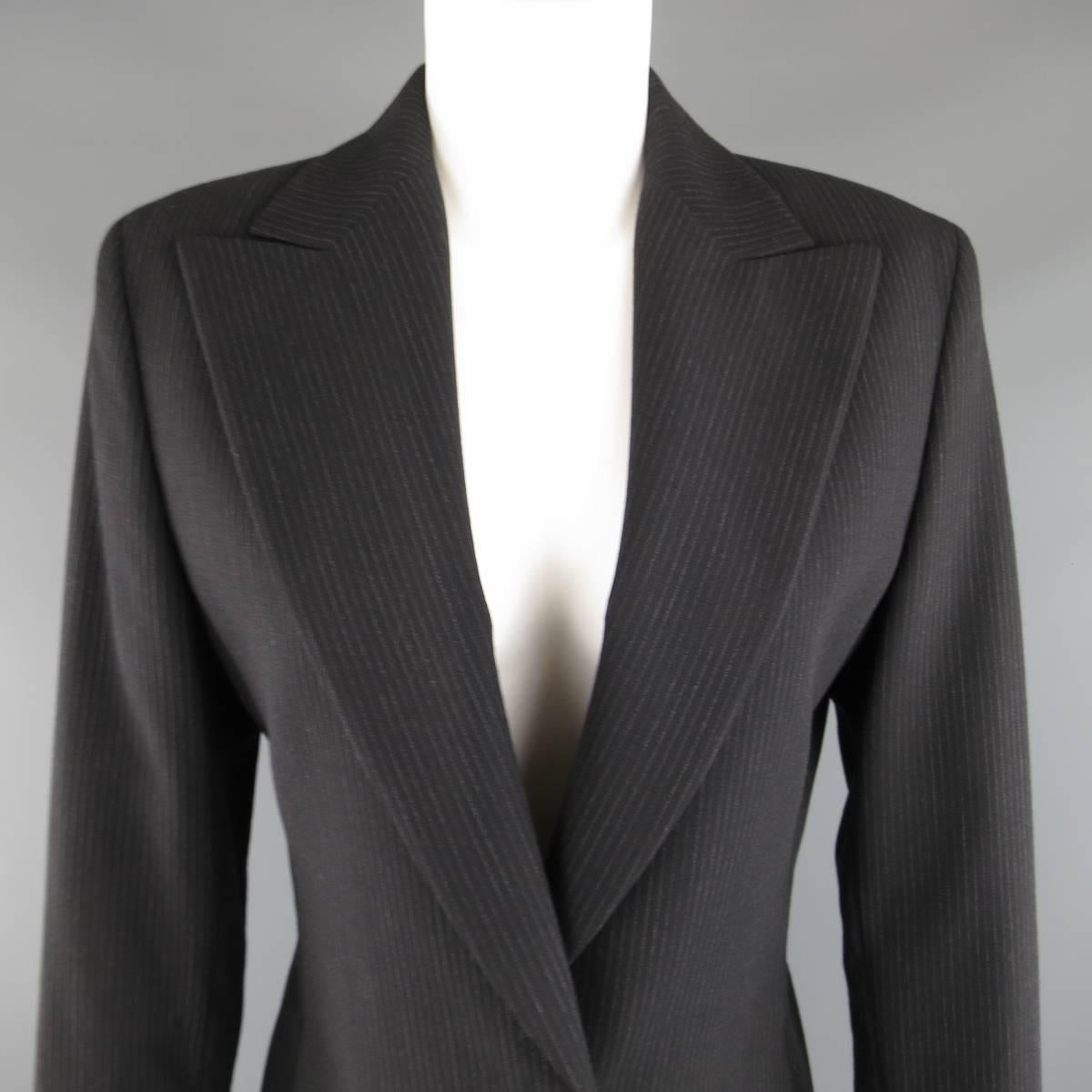 Vintage 1990's GIANNI VERSACE COUTURE blazer comes in a black pinstripe material and features a wide peak lapel,, cropped silhouette, and single button closure with black Greek pattern embossed V buttons. Minor wear on buttons. Made in Italy.
 
Good