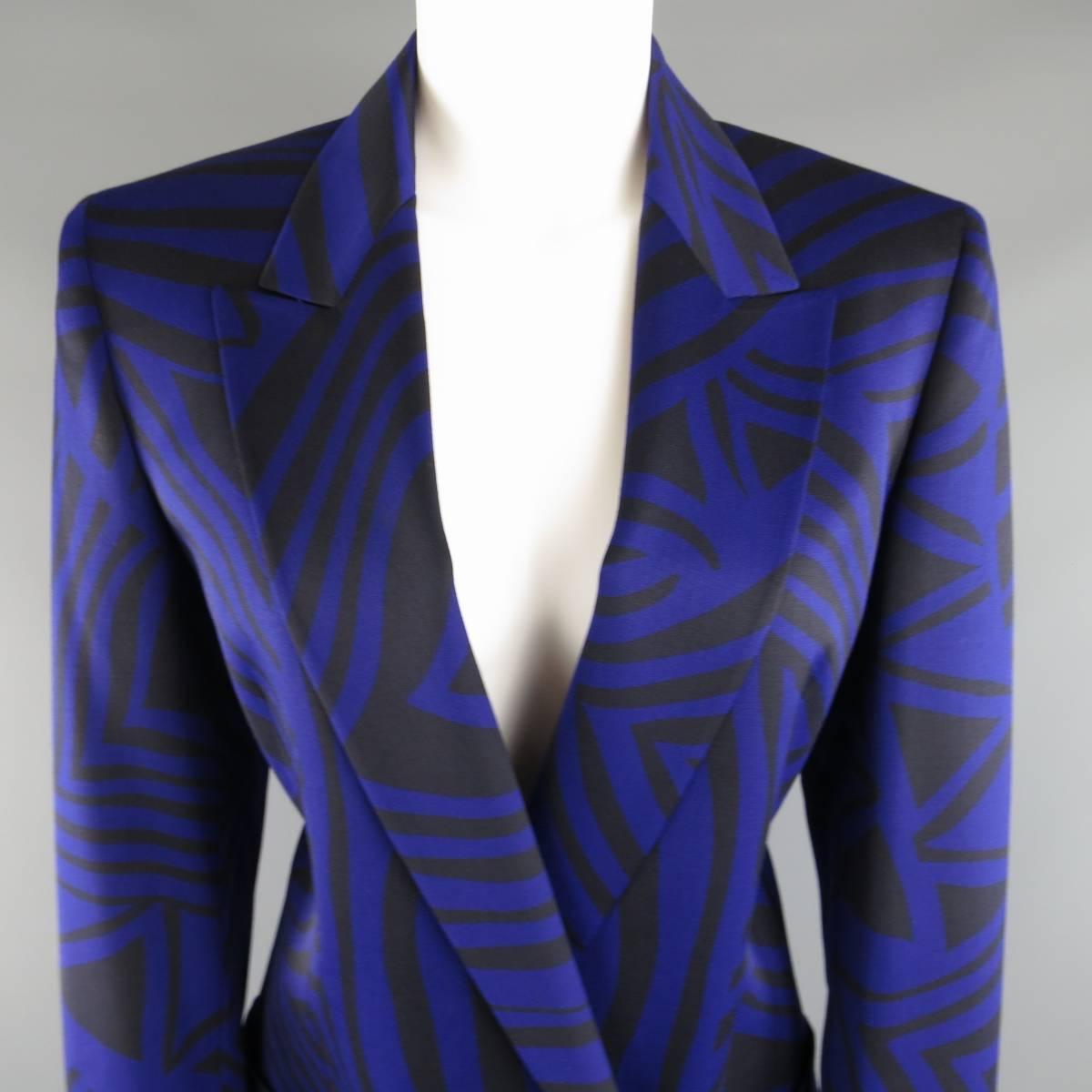 This fabulous vintage 1980's GIANNI VERSACE skirt suit comes in a royal purple and black zebra tribal print wool and includes a double breasted, peak lapel blazer with silver tone Art Deco buttons and a matching pencil skirt. Made in Italy.
