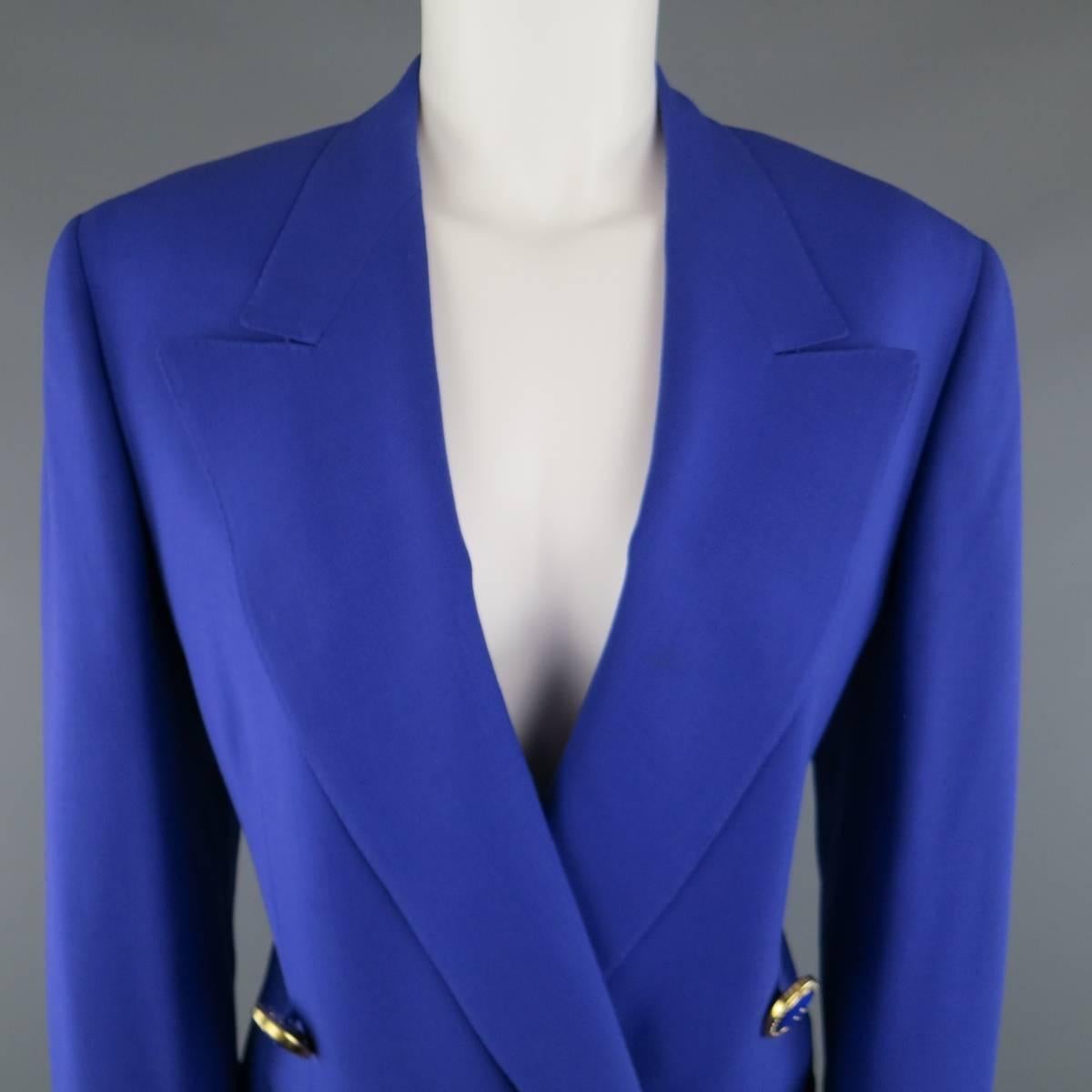 Vintage 1980's GIANNI VERSACE COUTURE skirt suit comes in a vibrant purple wool material and includes a double breasted, peak lapel, blazer with gold tone statement buttons and a matching A line pencil skirt. Made in Italy.
 
Excellent Pre-Owned
