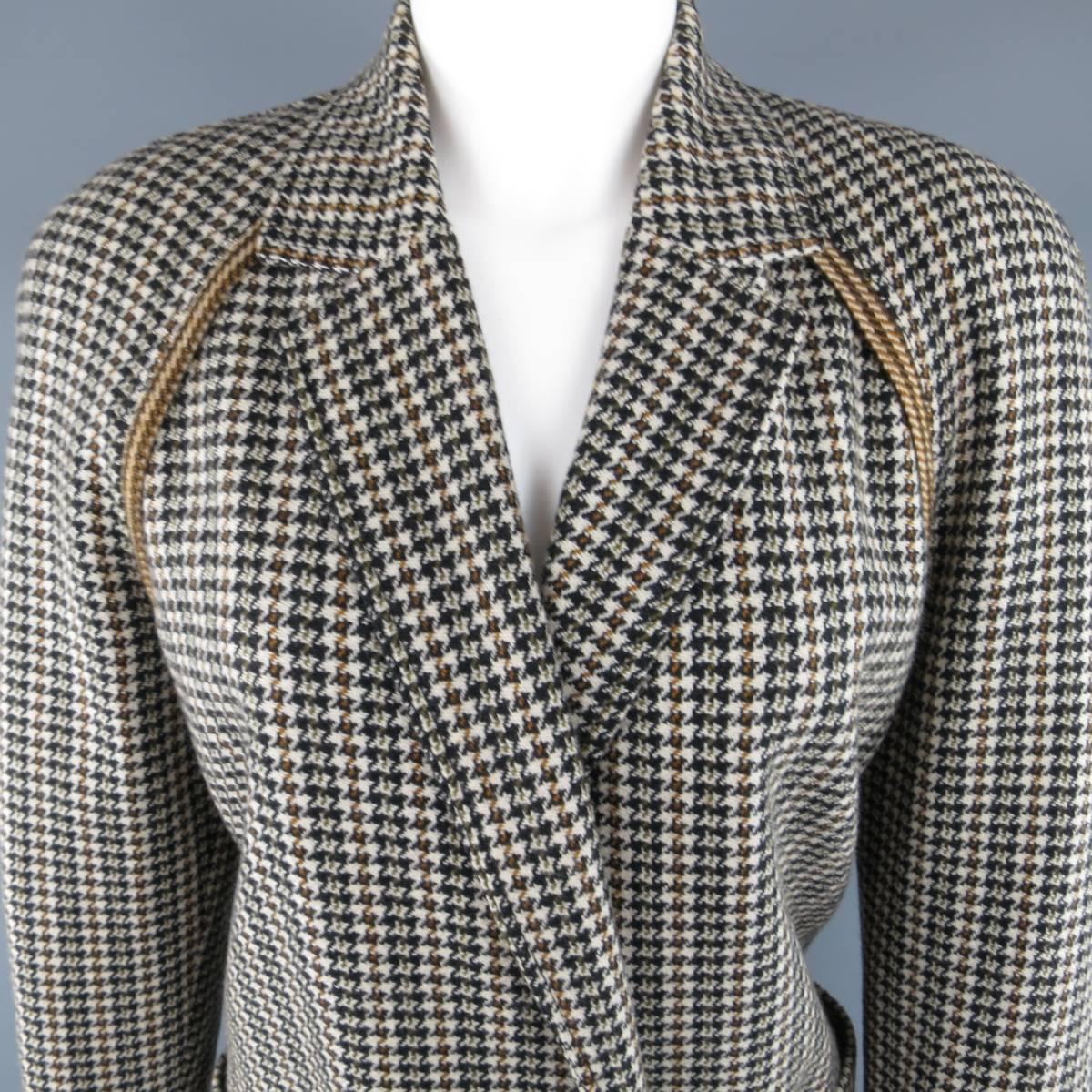 Vintage 1980s GIANNI VERSACE jacket comes in a beige houndstooth print with hues of olive green, brown, and black and features a notch lapel, double breasted button closure, and raglan sleeves with tan plaid trim. Made in Italy.
 
Excellent