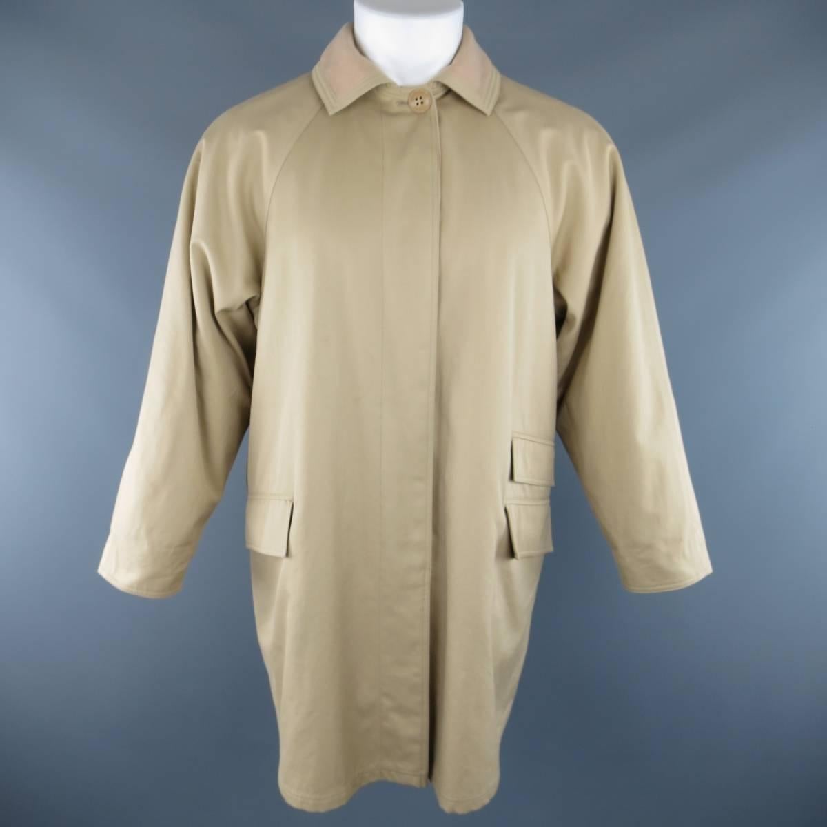 Vintage 1990s GIANNI VERSACE coat comes in classic khaki beige twill and features a hidden placket button up closure, raglan sleeves, triple flap pockets, and beige fleece lining and collar. Discoloration at chest shown in detail short. As-Is. Belt