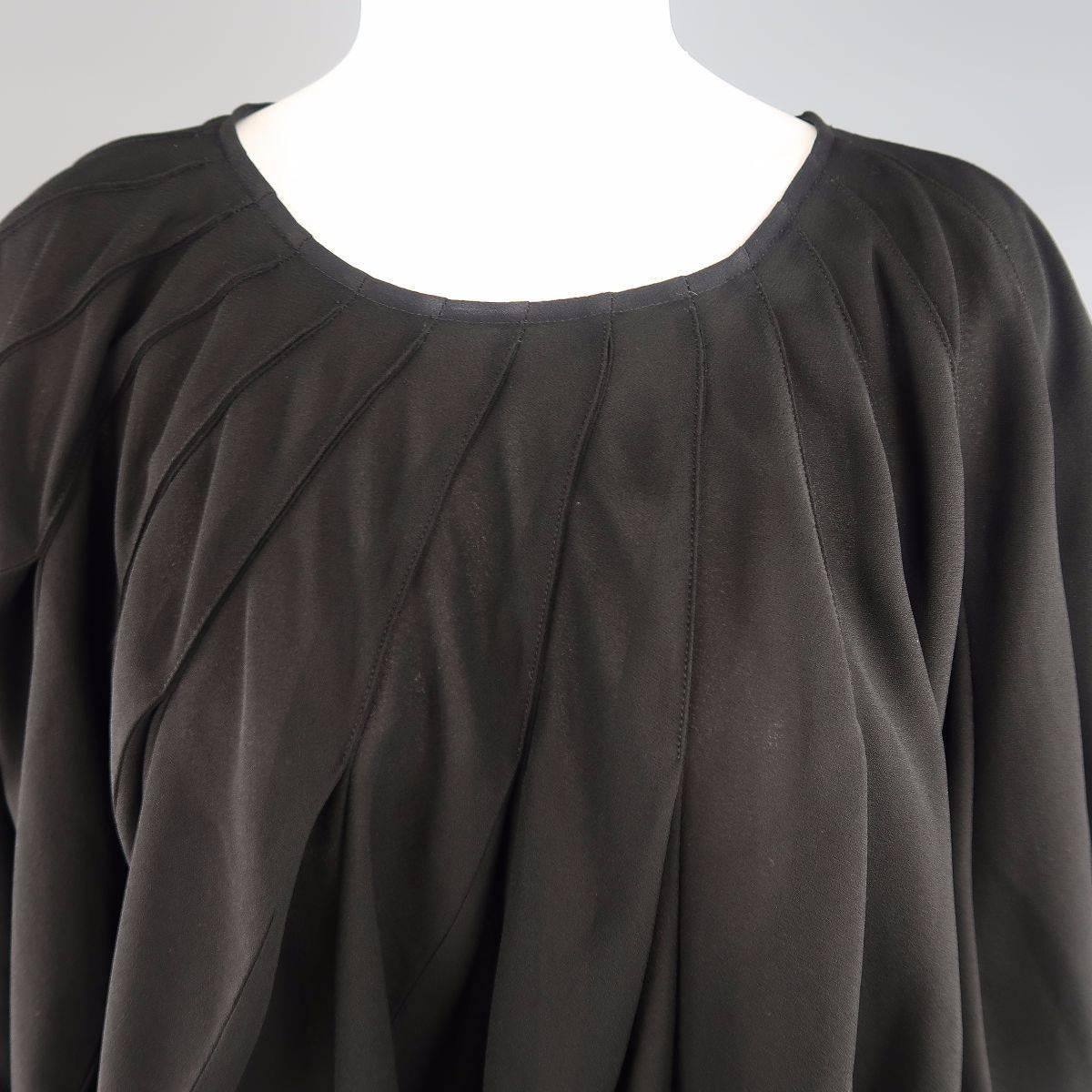 JUNYA WATANABE COMME des GARCONS poncho style bubble blouse comes in a black semi sheer crepe and features an all over pleated ruffle construction with side slits. Made in Japan.
 
Excellent Pre-Owned Condition.
Marked: S
 
Measurements:
 
Shoulder: