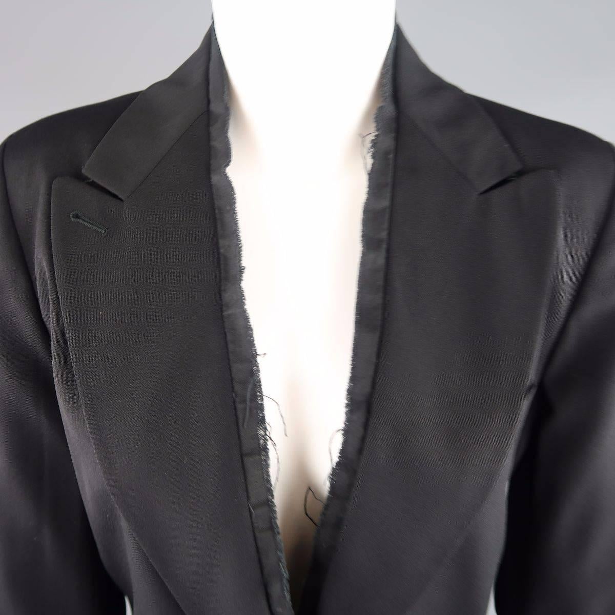 ANN DEMEALEMEESTER blazer jacket comes in black wool fabric and features a large peak lapel, single button closure, internal tie detail, and raw edge piping along the neck line. Made in Italy.
 
Good Pre-Owned Condition.
Marked: 40
 
Measurements:
