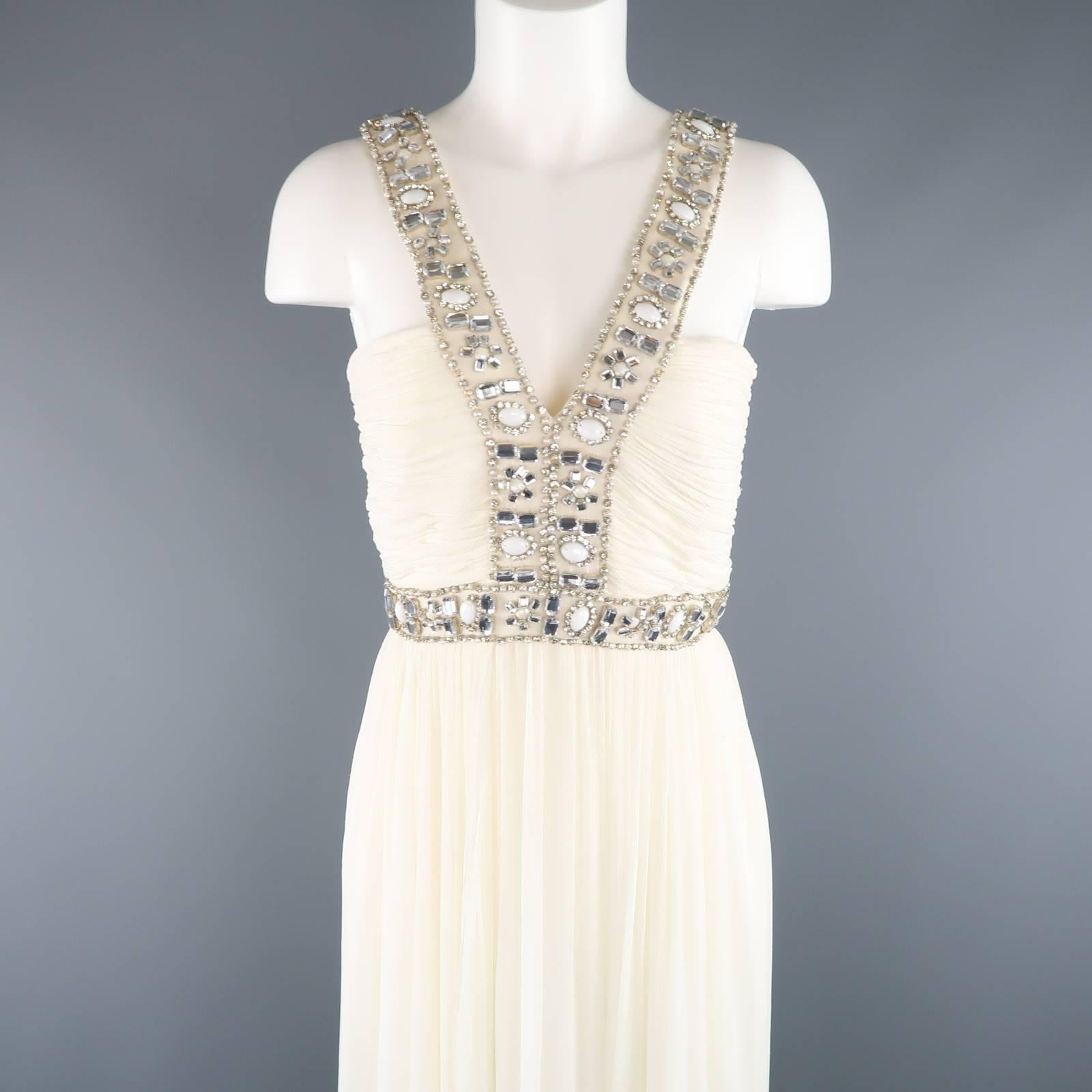 Gorgeous NAEEM KHAN evening gown comes in cream silk crepe chiffon and features a pleated bodice with rhinestone beaded straps and gathered skirt with overlay panel. Wear throughout. 
 
Good Pre-Owned Condition.
Marked: (no tags)
 
Measurements:
