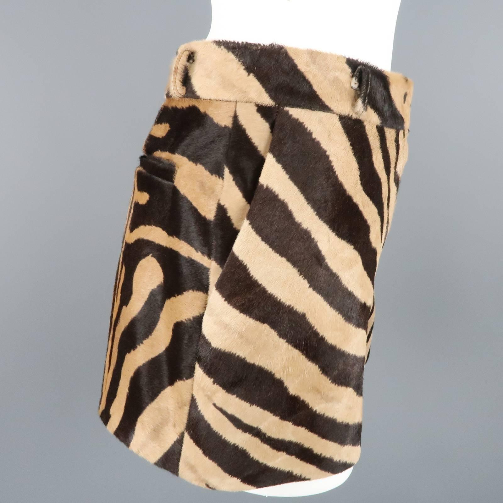 EMILIO PUCCI shorts come in a tan and chocolate brown pony hair leather with all over tiger animal print and feature a high rise and hidden zip closure. Spring 2015. Made in Italy.
 
Good Pre-Owned Condition. Retails: $2,489.00.
Marked: 36
