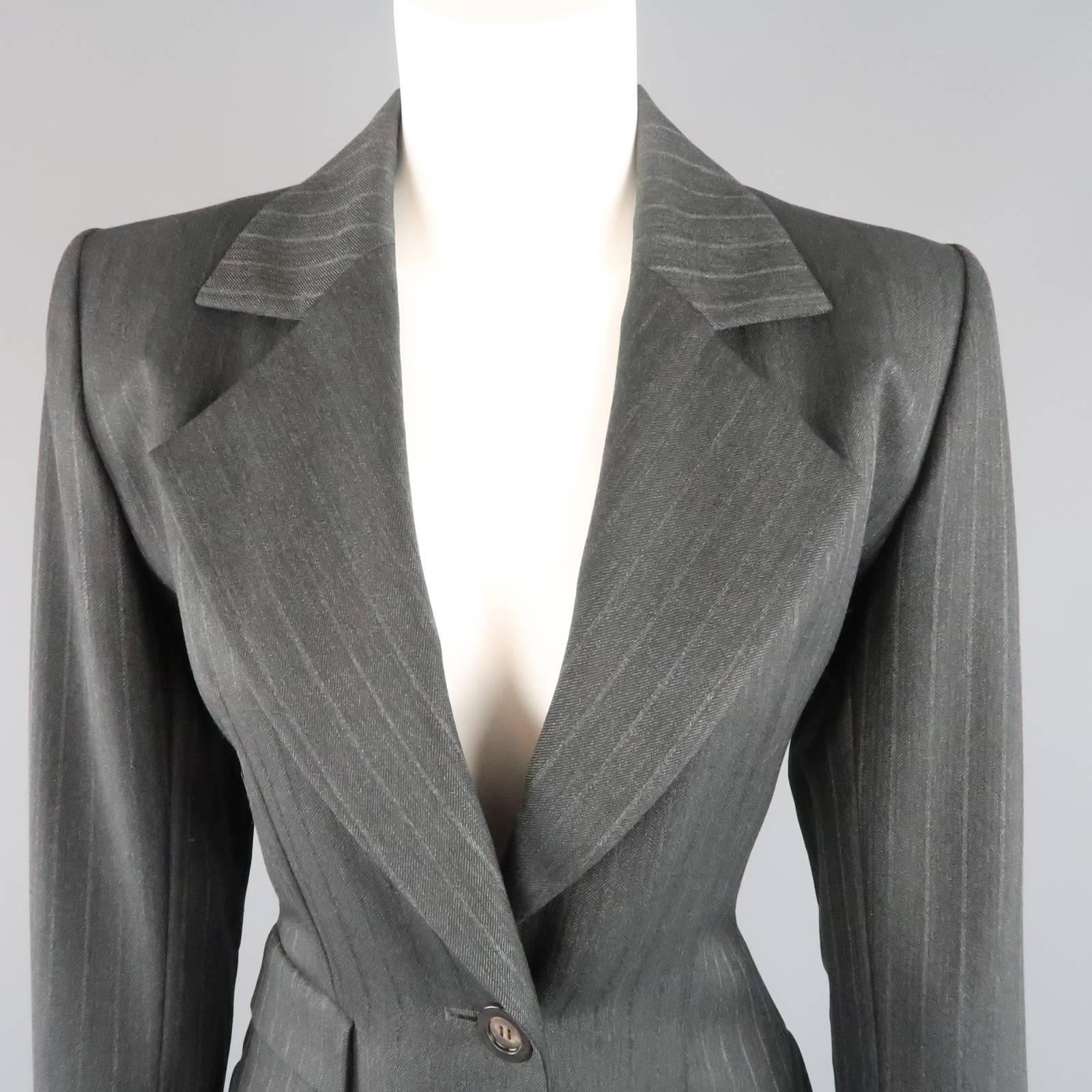 Vintage YVES SAINT LAURENT RIVE GAUCHE oversized blazer comes in a classic pinstripe wool and features a pointed lapel, triple flap pockets, and chic single button closure. Made in France.
 
Excellent  Pre-Owned Condition.
Marked: 38
