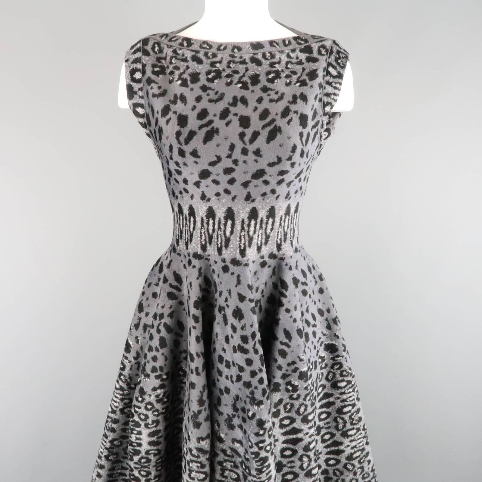 This gorgeous ALAIA Fall 2011 Collection sleeveless cocktail dress comes in a gray cheetah leopard print slightly fuzzy textured stretch knit and features a fit to flair silhouette with a ruffled A line skirt and boat neck line. Tags removed.