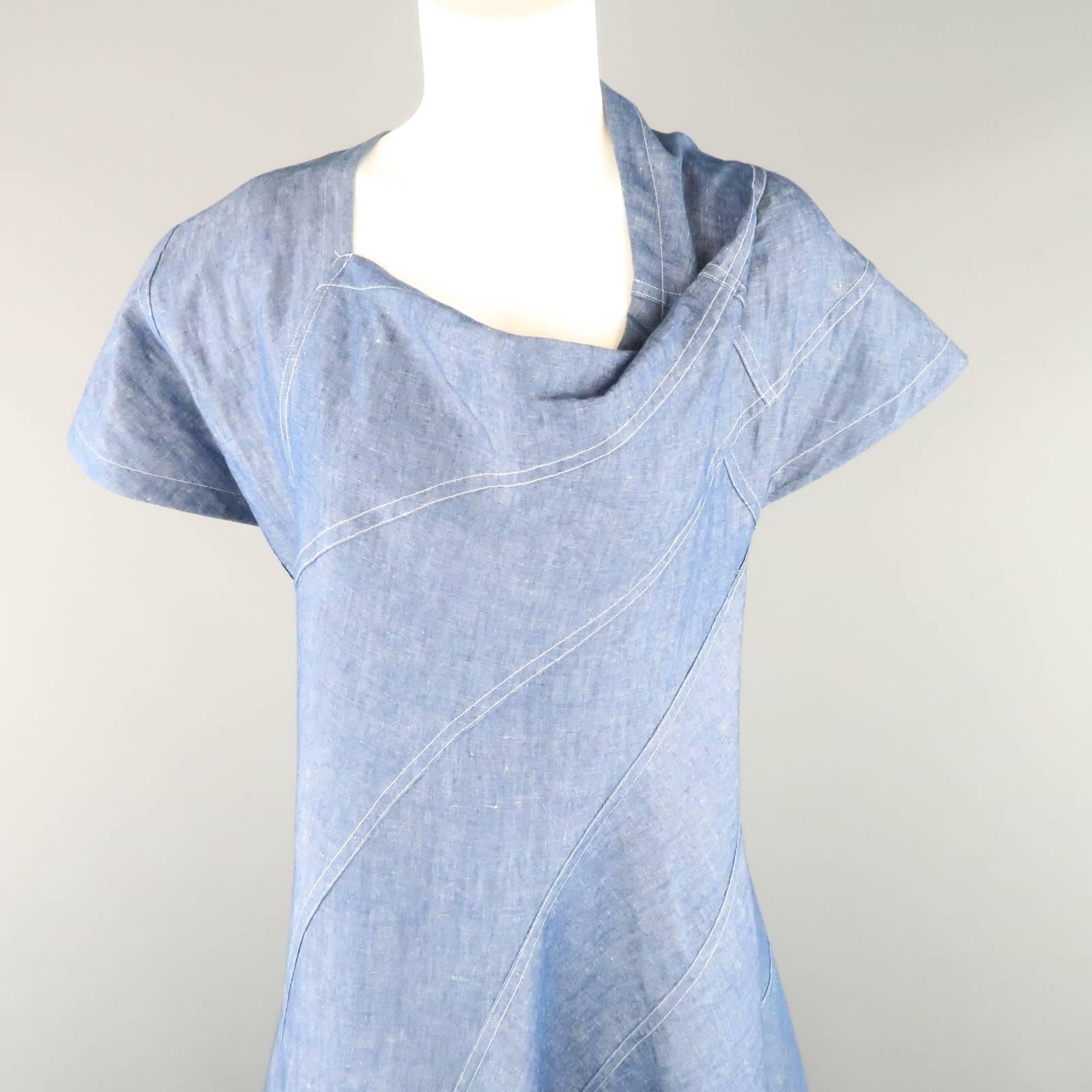 This unique JUNYA WATANABE Comme des Garcons DENIM dress comes in a cotton linen blend denim blue material and features an all over patchwork construction, asymmetrical draped neckline, and flaired skirt. Made in Hungary.
 
Excellent Pre-Owned