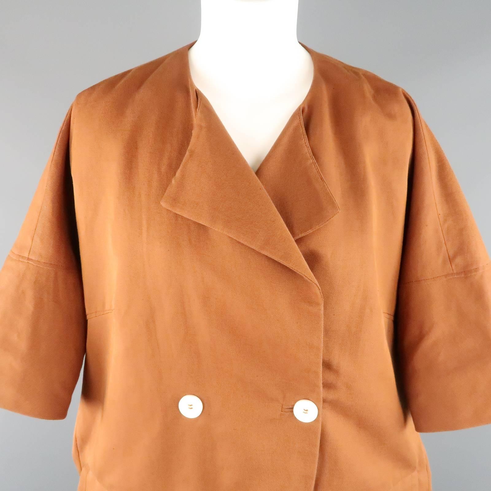 MARNI oversized cacoon coat comes in a gorgeous rust cotton linen blend twill and features a round neck with pointed half lapel, double breasted cream button closure, flap pockets, and drop shoulder with cropped sleeves. Small mark on back. As-Is.