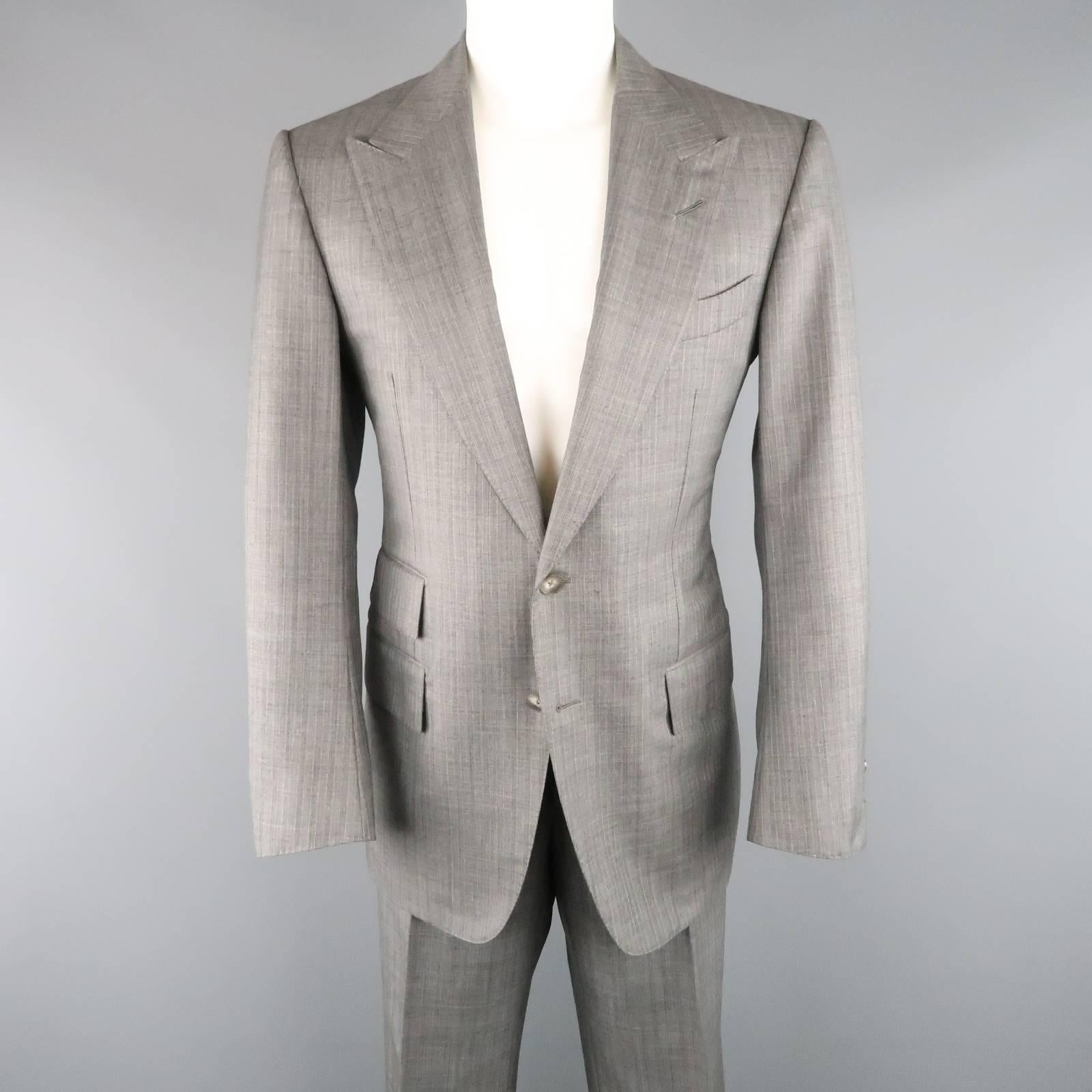 Classic TOM FORD suit comes in a silver gray herringbone stripe wool and includes a two button, single breasted, peak lapel sport coat and matching cuffed hem, straight leg trousers with side tabs. Made in Italy.
 
Excellent Pre-Owned