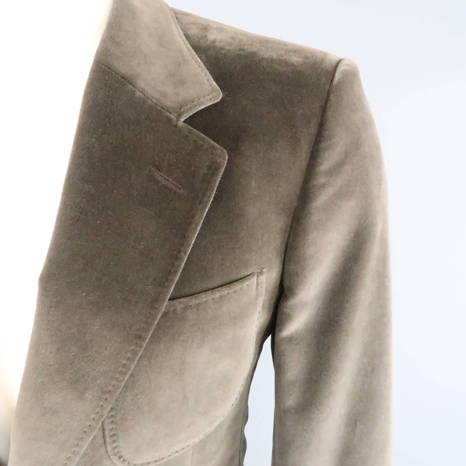 YVES SAINT LAURENT by TOM FORD sport coat comes in dark taupe velvet and features a notch lapel, triple patch pockets, unique tab button cuffs, and top stitching throughout. Snag on lapel. As-Is.
 
Good Pre-Owned Condition.
Marked: 44 R
