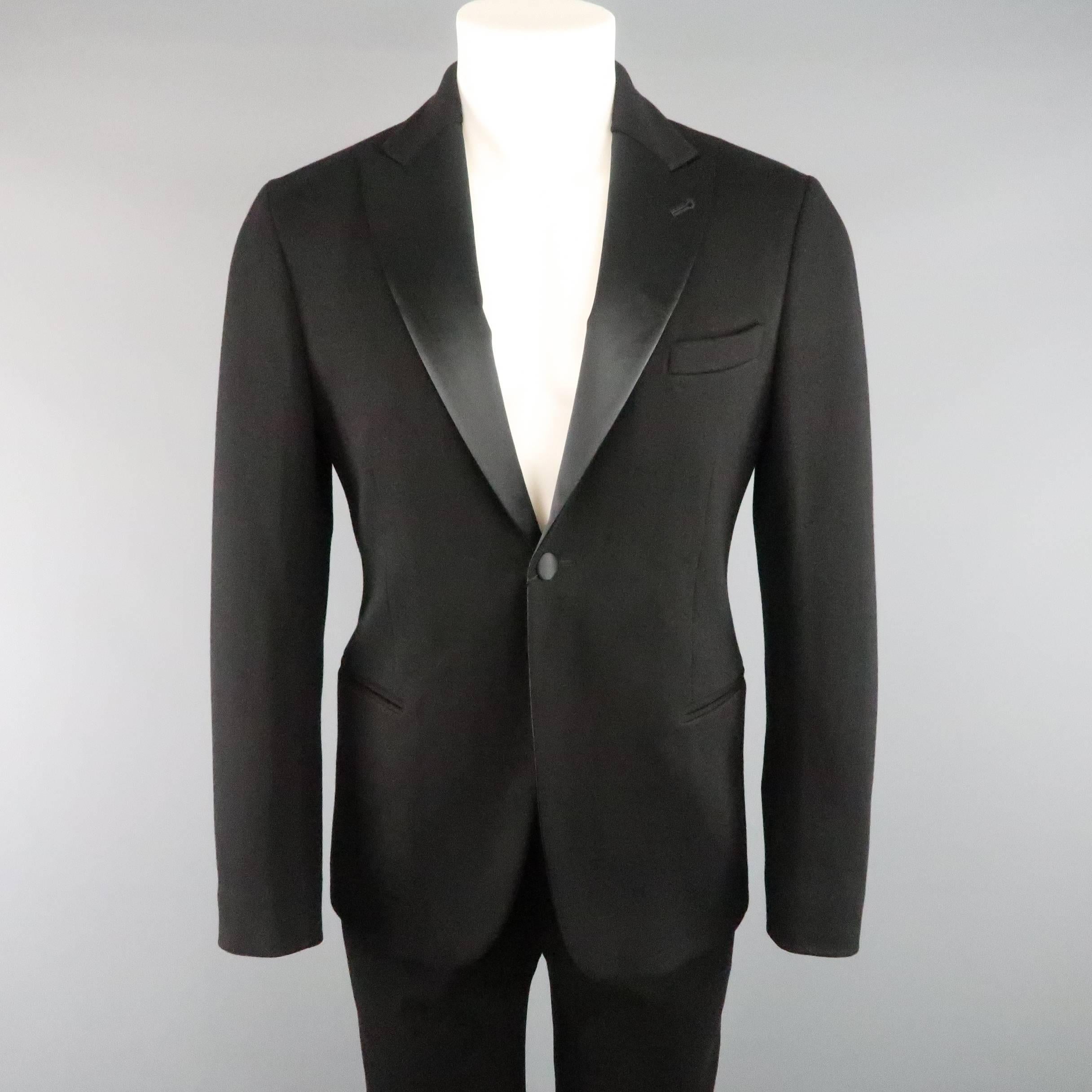 GIORGIO ARMANI tuxedo comes in a soft jersey material and includes a classic single button, satin lined, peak lapel jacket with faux slit pockets and matching satin stripe tuxedo pants. Made in Italy.
 
Retails: $3,195.00
New with Tags.
Marked: IT