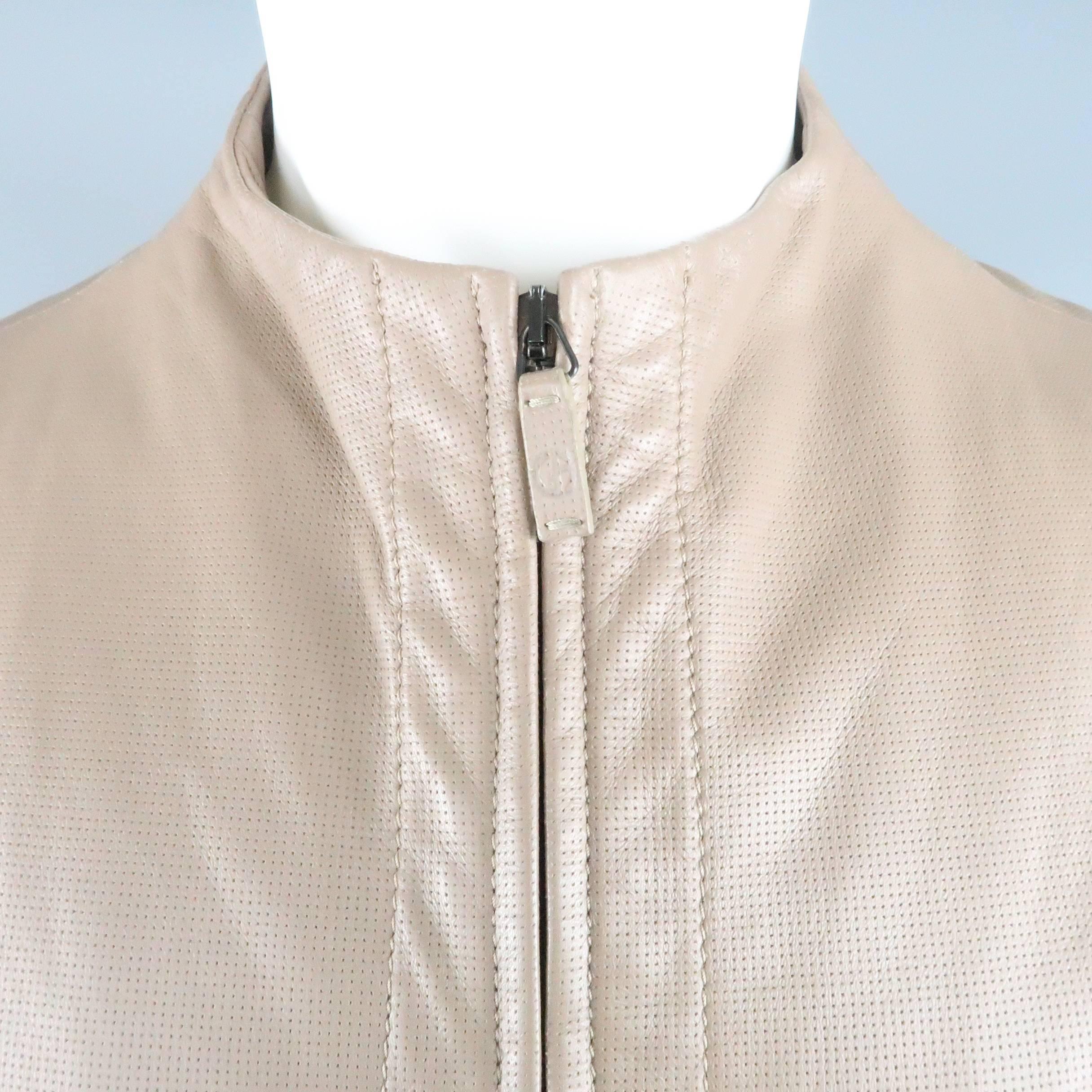 GIORGIO ARMANI biker jacket comes in taupe perforated lambskin leather and features a high, collarless crewneck, double zip closure, and tab cuffs. Made in Italy.
 
Excellent Pre-Owned Condition.
Marked:
 
Measurements:
 
Shoulder: 18 in.
Chest: 40