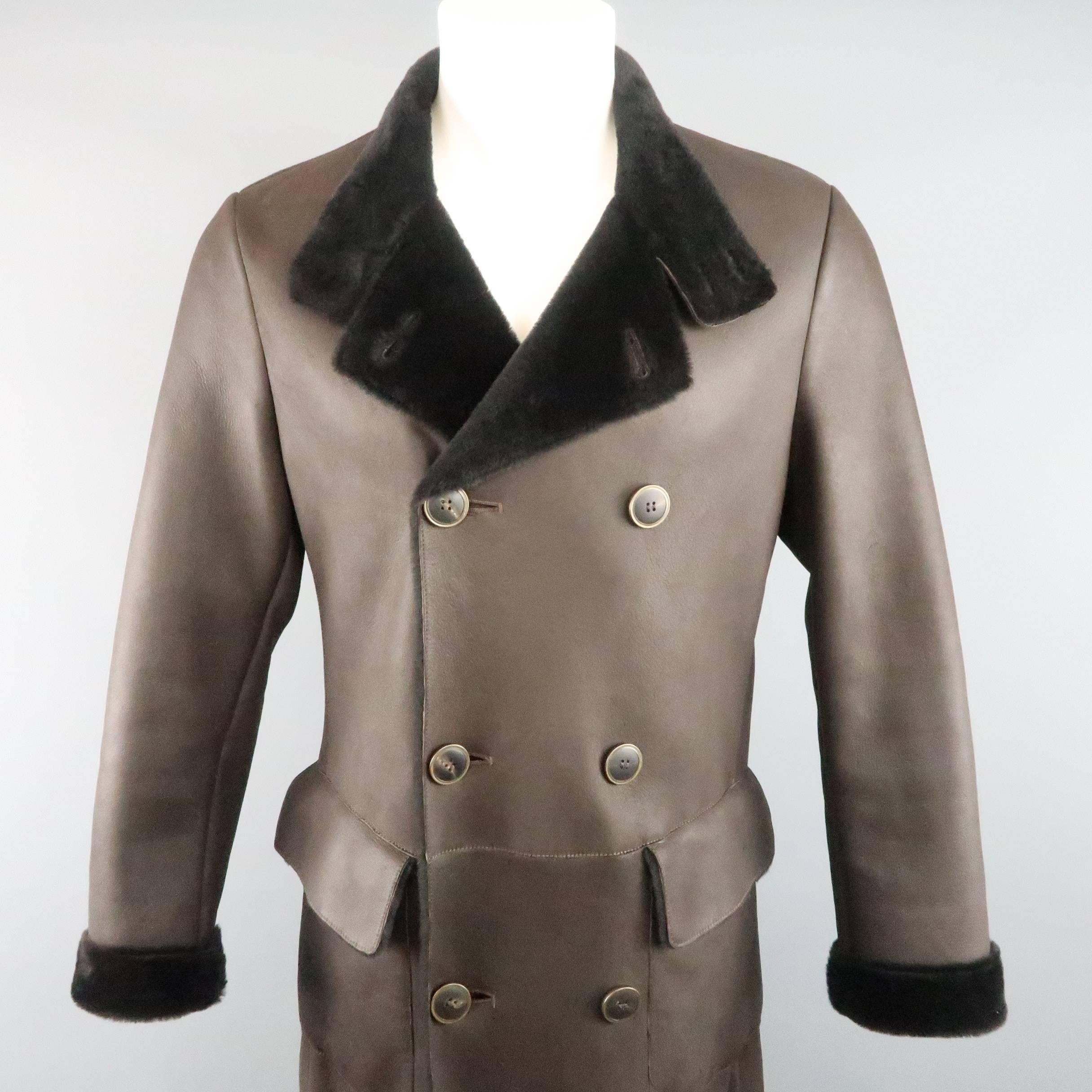 GIORGRIO ARMANI winter coat comes in chocolate brown fur shearling leather and features a double breasted button front, high collar, and flap pockets. Made in Italy.
 
Excellent Pre-Owned Condition.
Marked: IT 48
 
Measurements:
 
Shoulder: 17