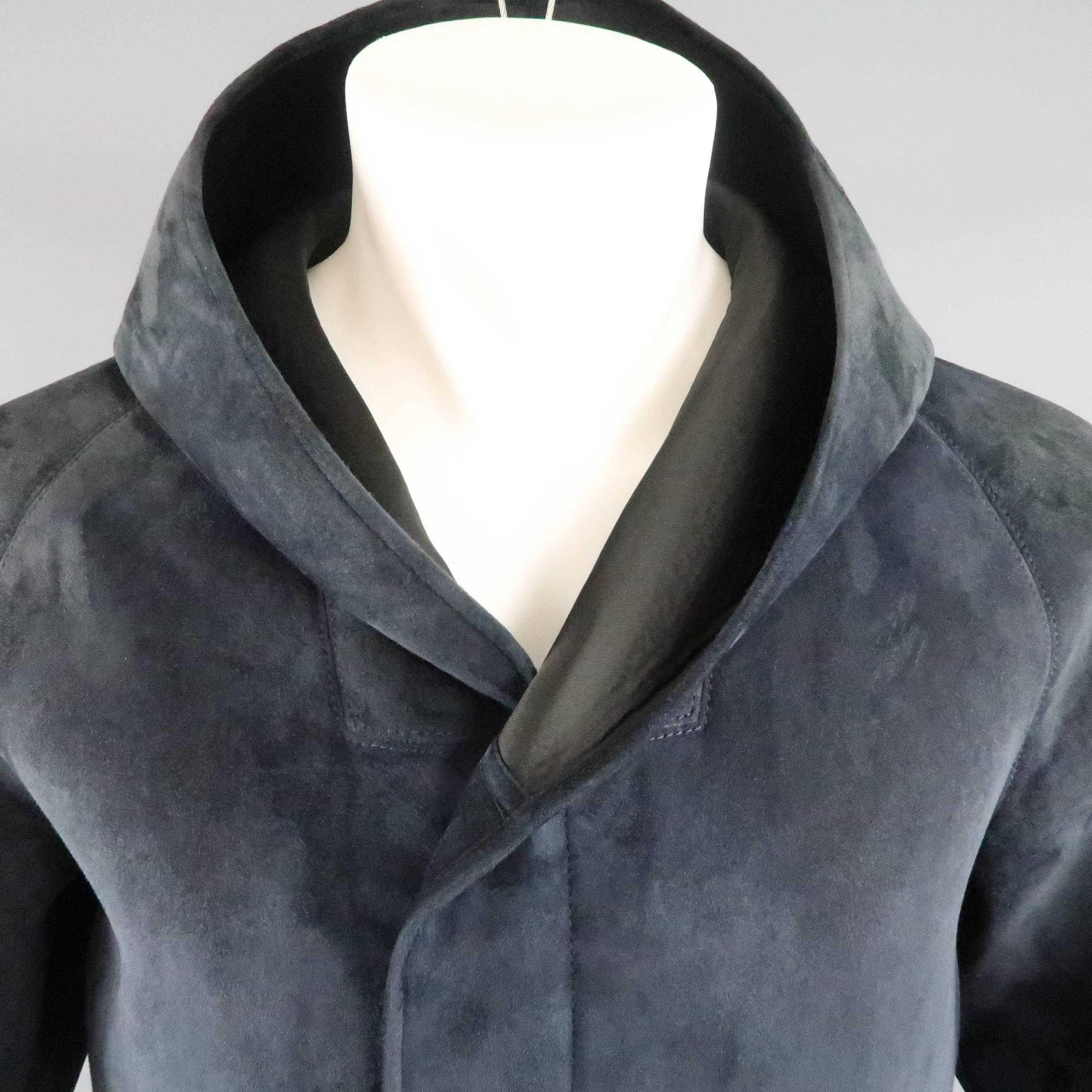 GIORGIO ARMANI jacket comes in a teal navy neoprene bonded nubuck sueded leather and features a hidden placket zip and snap front, slanted zip pockets, and oversized hood. Minor discolorations on sides. As-Is. Made in Italy.
 
Good Pre-Owned