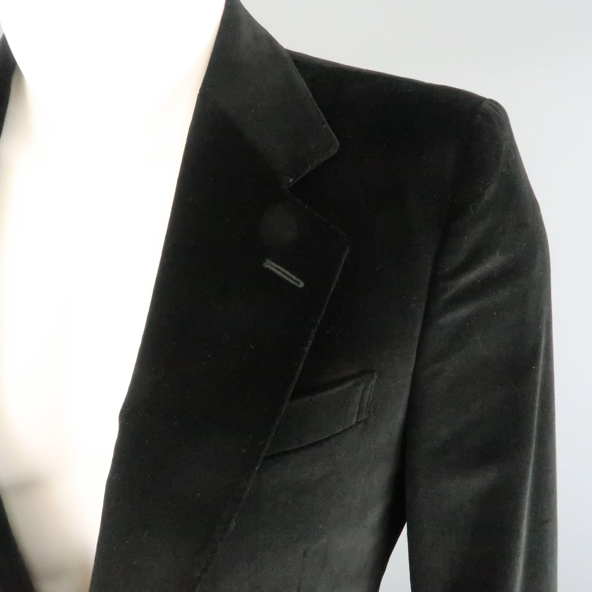 YVES SAINT LAURENT by TOM FORD sport coat comes in black cotton velvet and features a notch lapel with top stitching, two button closure, faux flap pockets, tab cuffs, and single vented back. Made in Italy.
 
Excellent Pre-Owned Condition.
Marked: