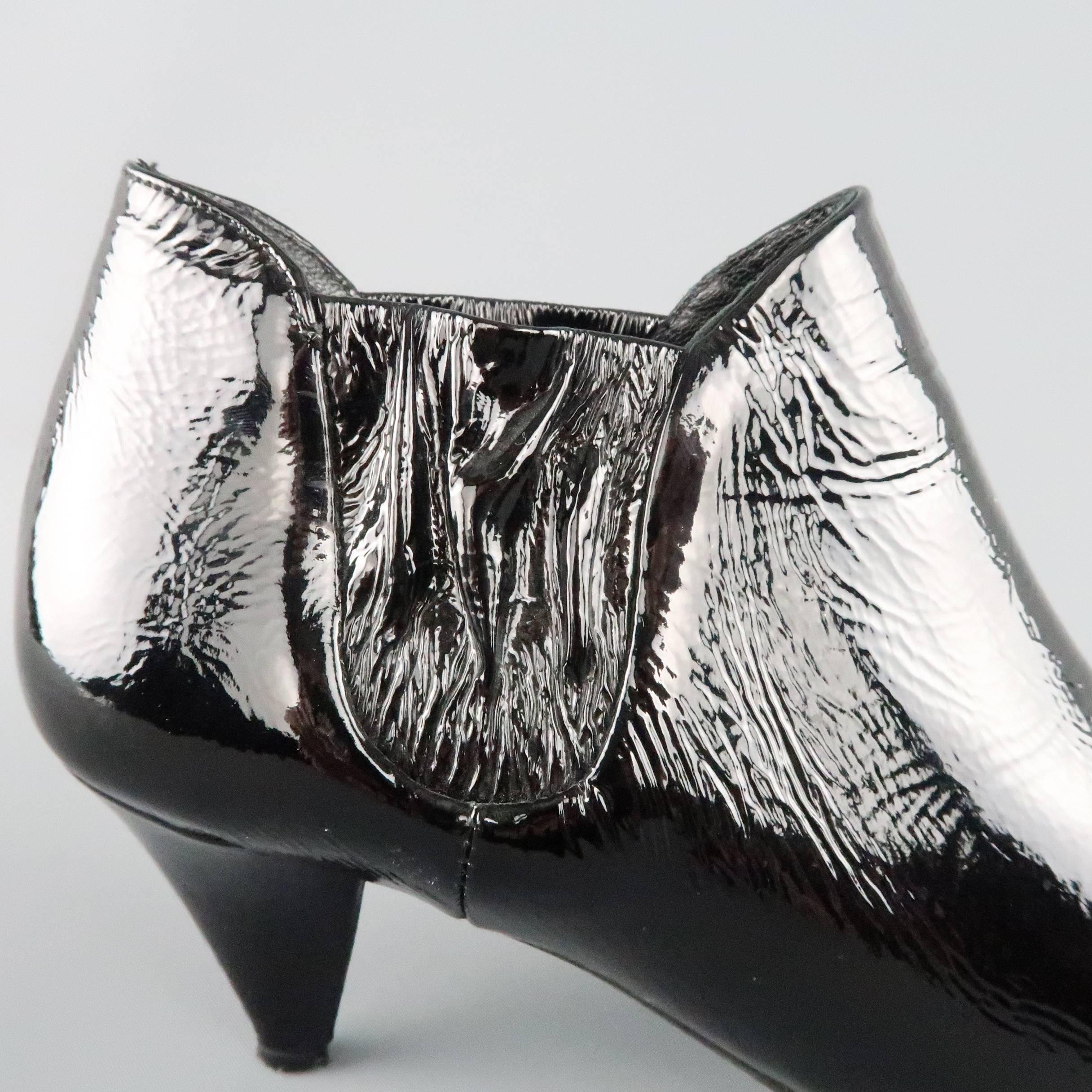 PRADA pull on ankle booties come in a textured patent leather and feature a pointed toe, rubber sole, and covered kitten heel. Made in Italy.
 
Excellent Pre-Owned Condition.
Marked: IT 37.5
 
Heel: 2.5 in.

SKU: 85145