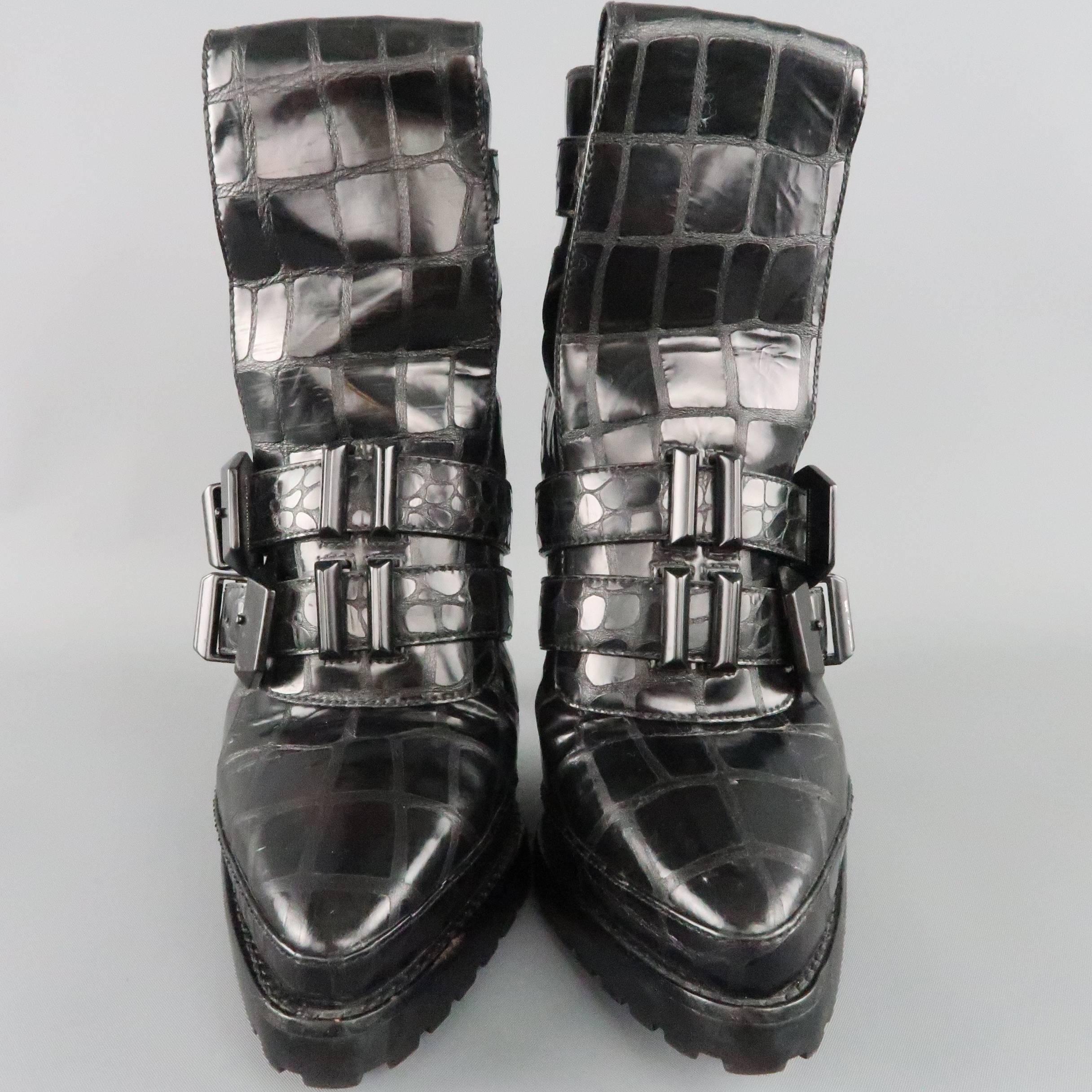 Iconic ALEXANDER WANG runway ankle boots from the Fall/Winter 2009 Collection come in shiny, alligator textured leather and feature a pointed toe, folded tongue, triple straps with black western hardware, thick commando sole, back zip closure, and