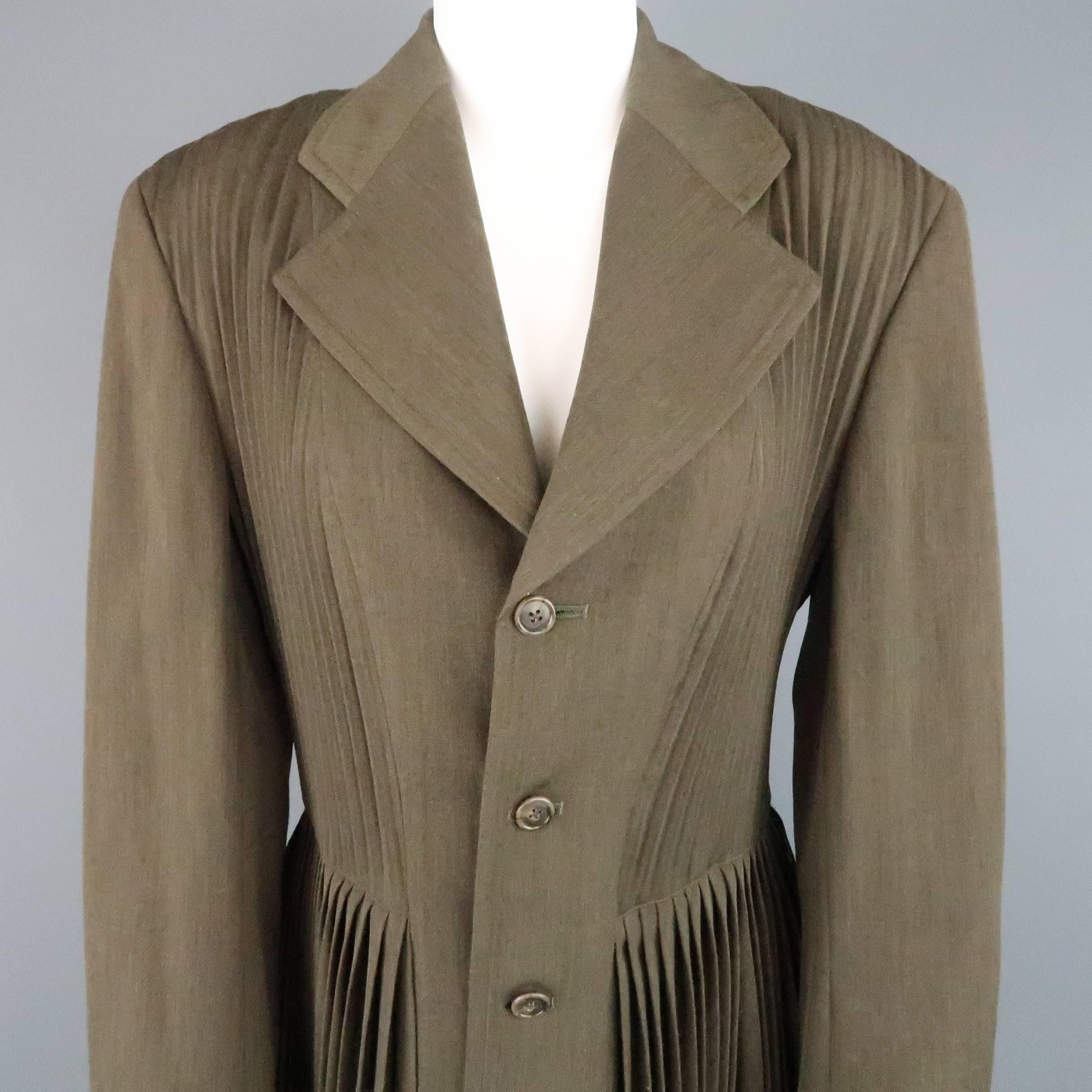 COMME des GARCONS sport coat jacket comes in an olive green wool blend and features a wide notch lapel, four button front, pleat textured top, and accordion pleated skirt. Made in Japan.
 
Excellent Pre-Owned Condition.
Marked: M
 
Measurements:
