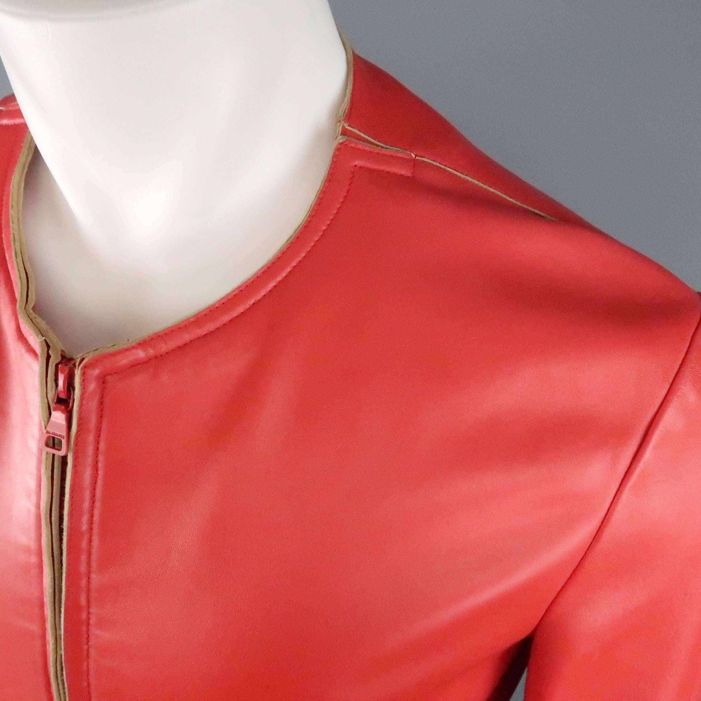JIL SANDER jacket comes in a soft, light weight red leather and features a round, collarless neckline, red double zip front, slit pockets, and beige raw edge details. Some very small spots throughout leather. As-Is. Made In Italy.
 
Good Pre-Owned