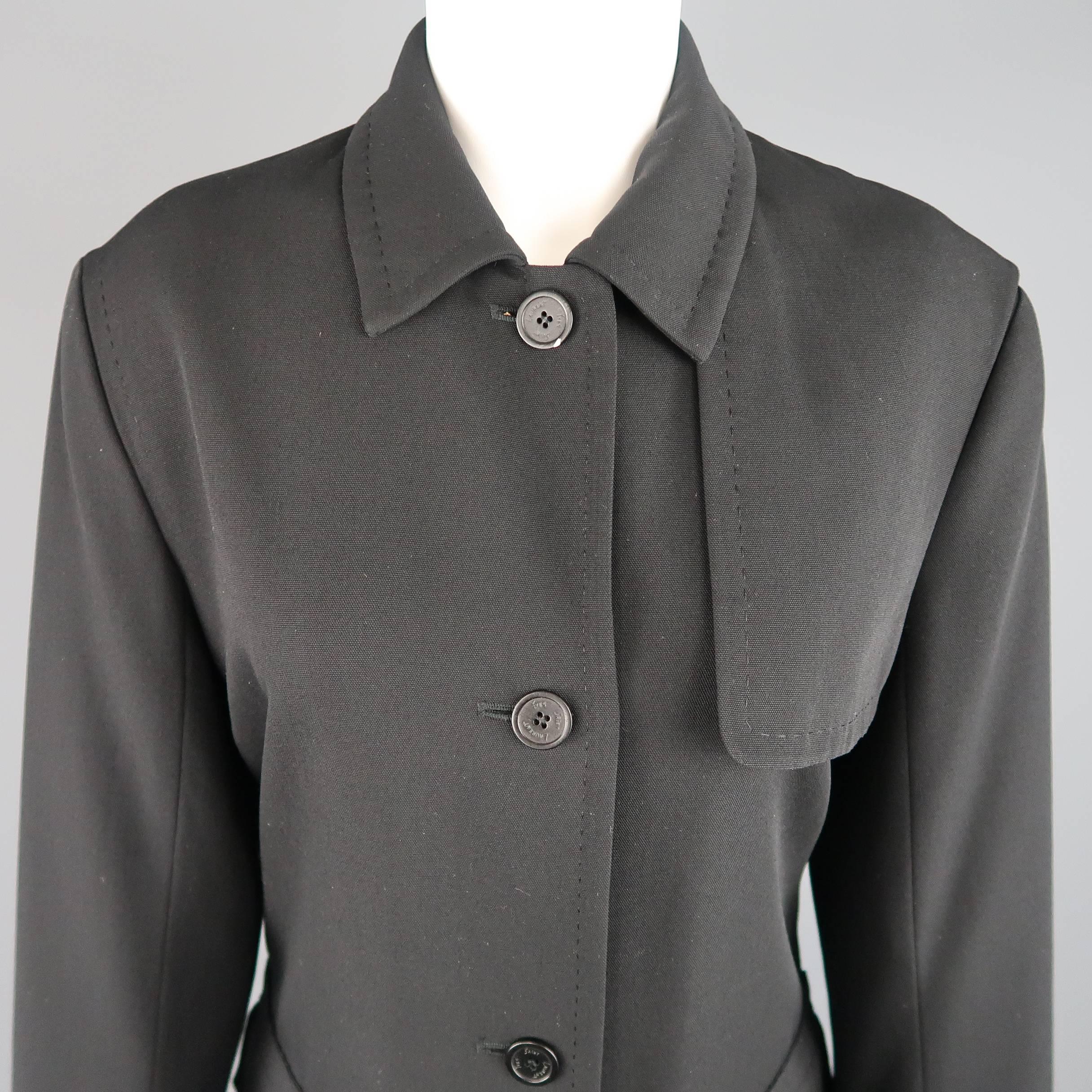 Vintage YVES SAINT LAURENT RIVE GAUCHE jacket comes in a black wool blend canvas with top stitching throughout and features a classic pointed collar, four button closure, patch flap pockets, asymmetrical storm flap, and belted cuffs. Made in