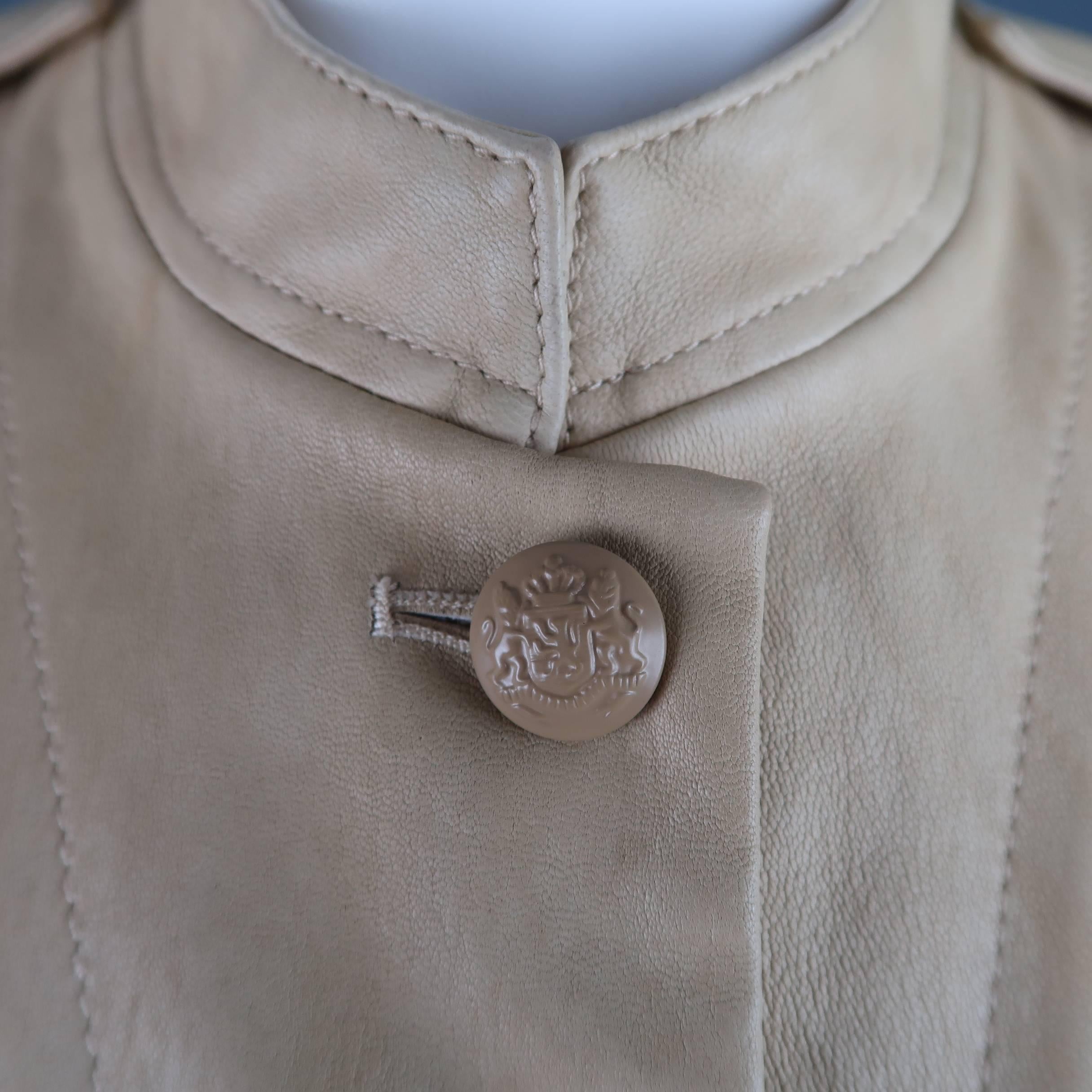 3.1 PHILLIP LIM safari jacket comes in smooth khaki beige leather and features  a band collar, beige coat of arms buttons, epaulets, side zips, and patch flap pockets. Minor wear throughout leather.
 
Good Pre-Owned Condition.
Marked: 8
