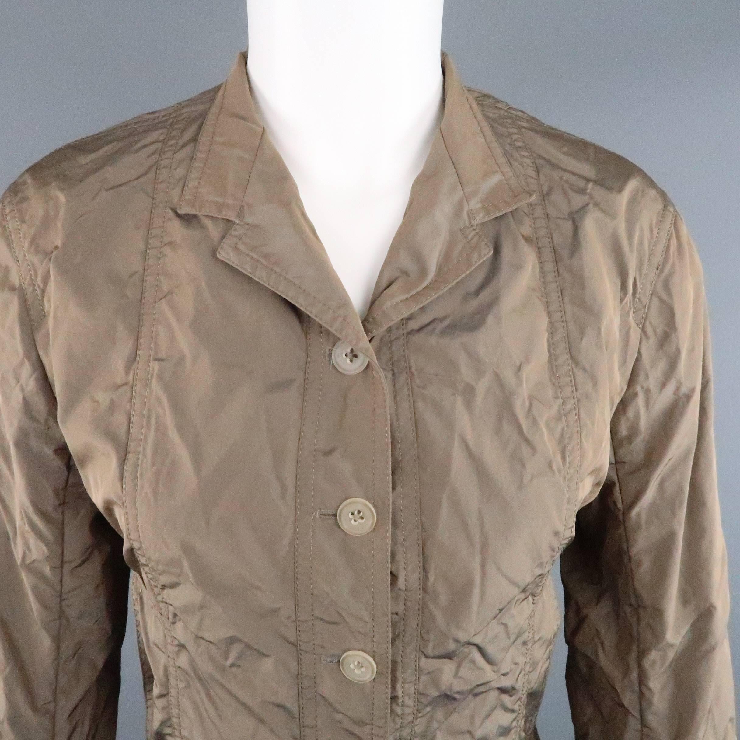 JIL SANDER sport coat comes in a light weight iridescent taupe taffeta and features a five button closure, slit pockets, and high collar. Made in Italy.
 
Excellent Pre-Owned Condition.
Marked: (no tag)
 
Measurements:
 
Shoulder: 16 in.
Bust: 36