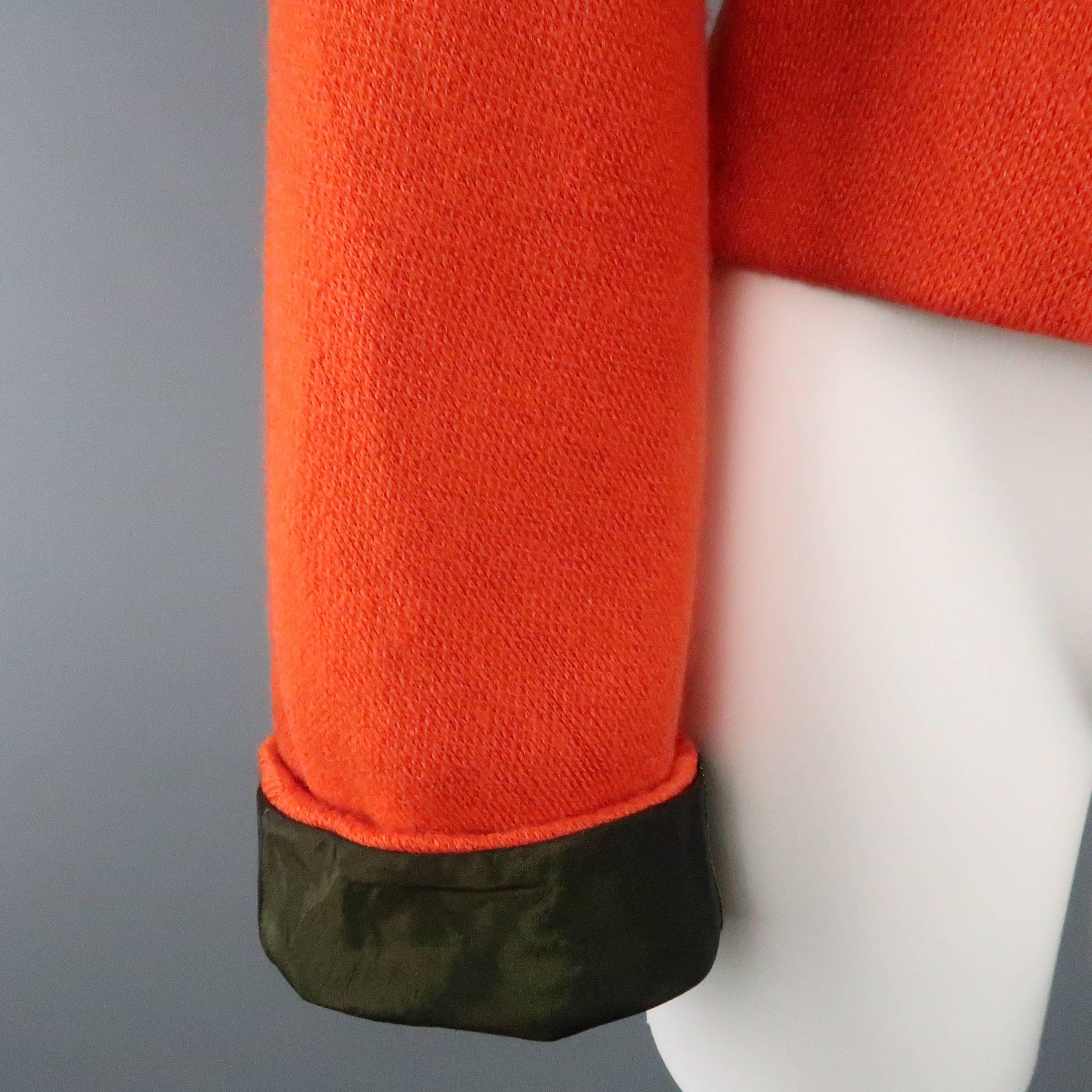 KRIZIA jacket comes in an bold orange mohair and wool blend knit and features a round, collarless neckline, hidden zip front, and long sleeves with olive green satin liner. Made in Italy.
 
Excellent Pre-Owned Condition.
Marked: IT 44
