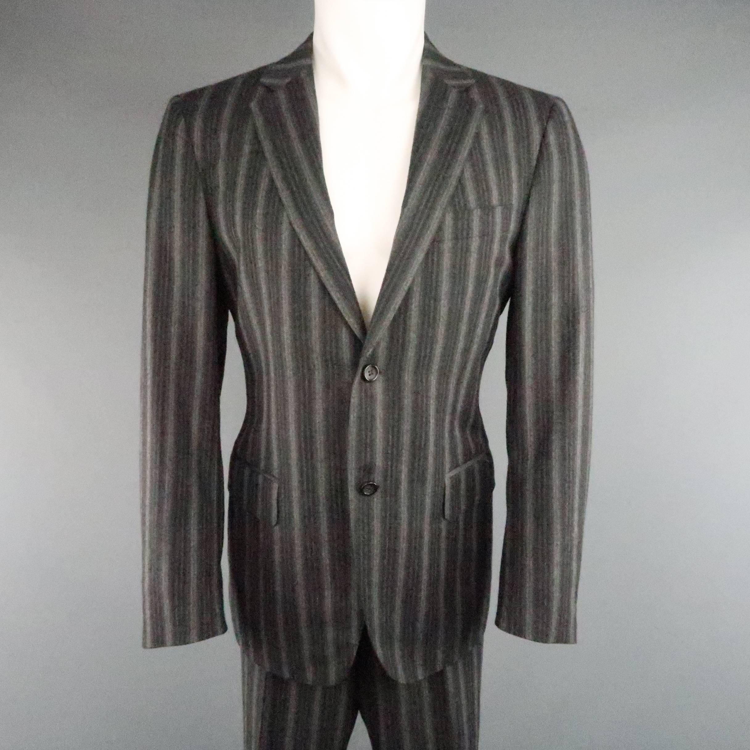 CANALI  two piece suit comes in a unique charcoal to gray gradient pinstripe wool cashmere blend and includes a notch lapel, single breasted, two button sport coat and matching flat front trousers. Made in Italy.
 
Excellent Pre-Owned