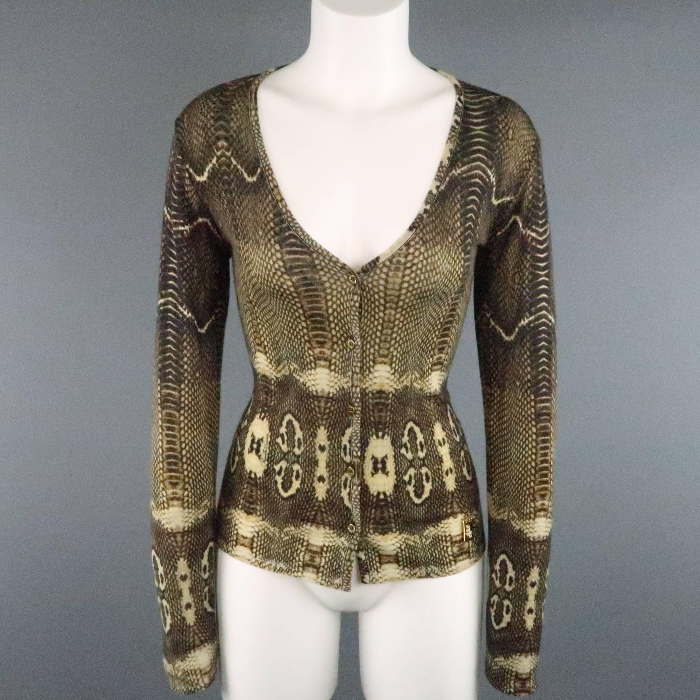 ROBERTO CAVALLI sweater set comes in a brown and gold cashmere, wool, & silk blend knit with all over python print and includes a v neck cardigan and sleeveless turtleneck pullover with metal rhinestone logo plaque. Made in Italy.
 
Excellent