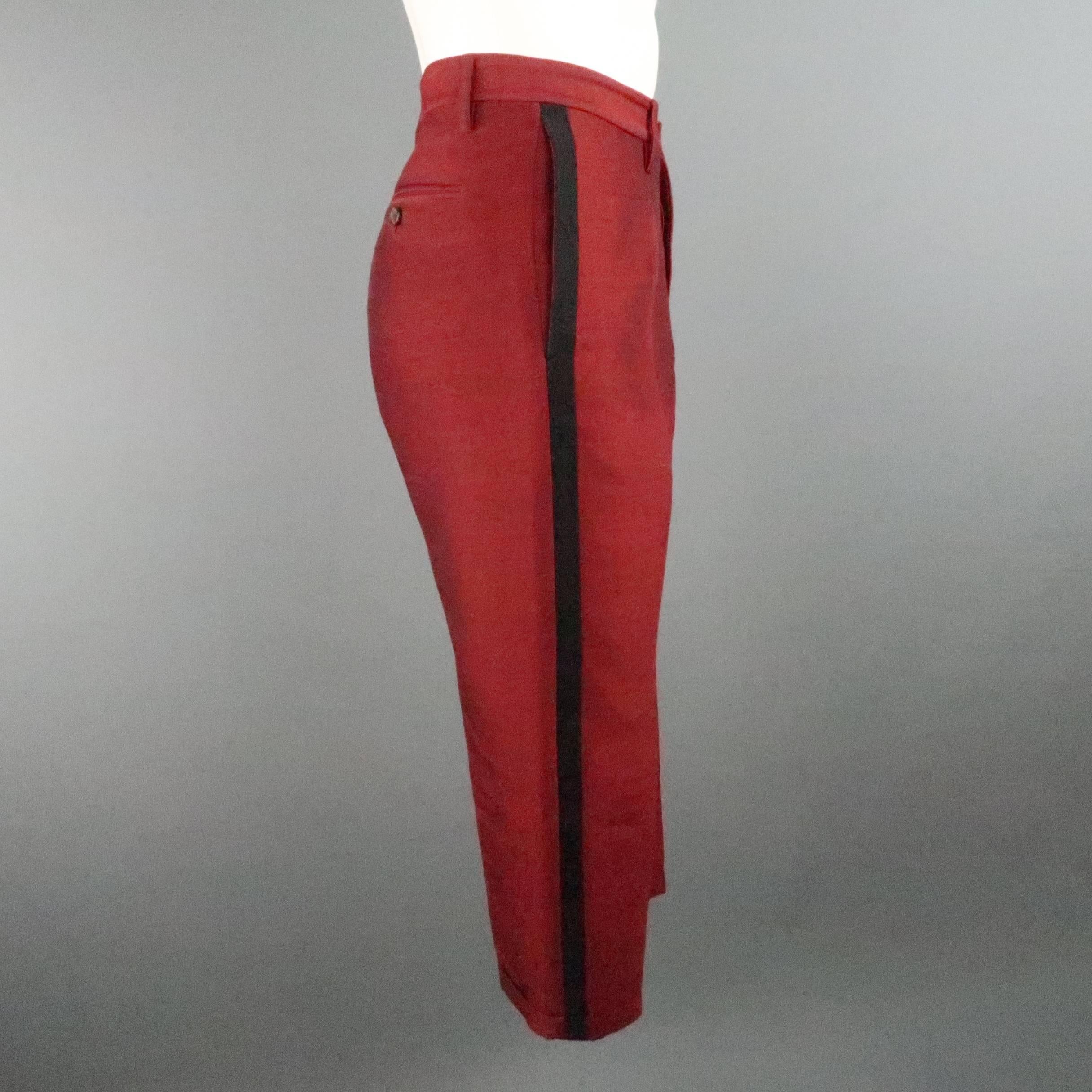 DSQUARED2 tuxedo pants come in a dark red heathered wool silk blend with a subtle sheen and feature a cropped hem with cuff, black tuxedo stripe, and extended back loop. Made in Italy.
 
Excellent Pre-Owned Condition.
Marked: IT 48
 
Measurements:
