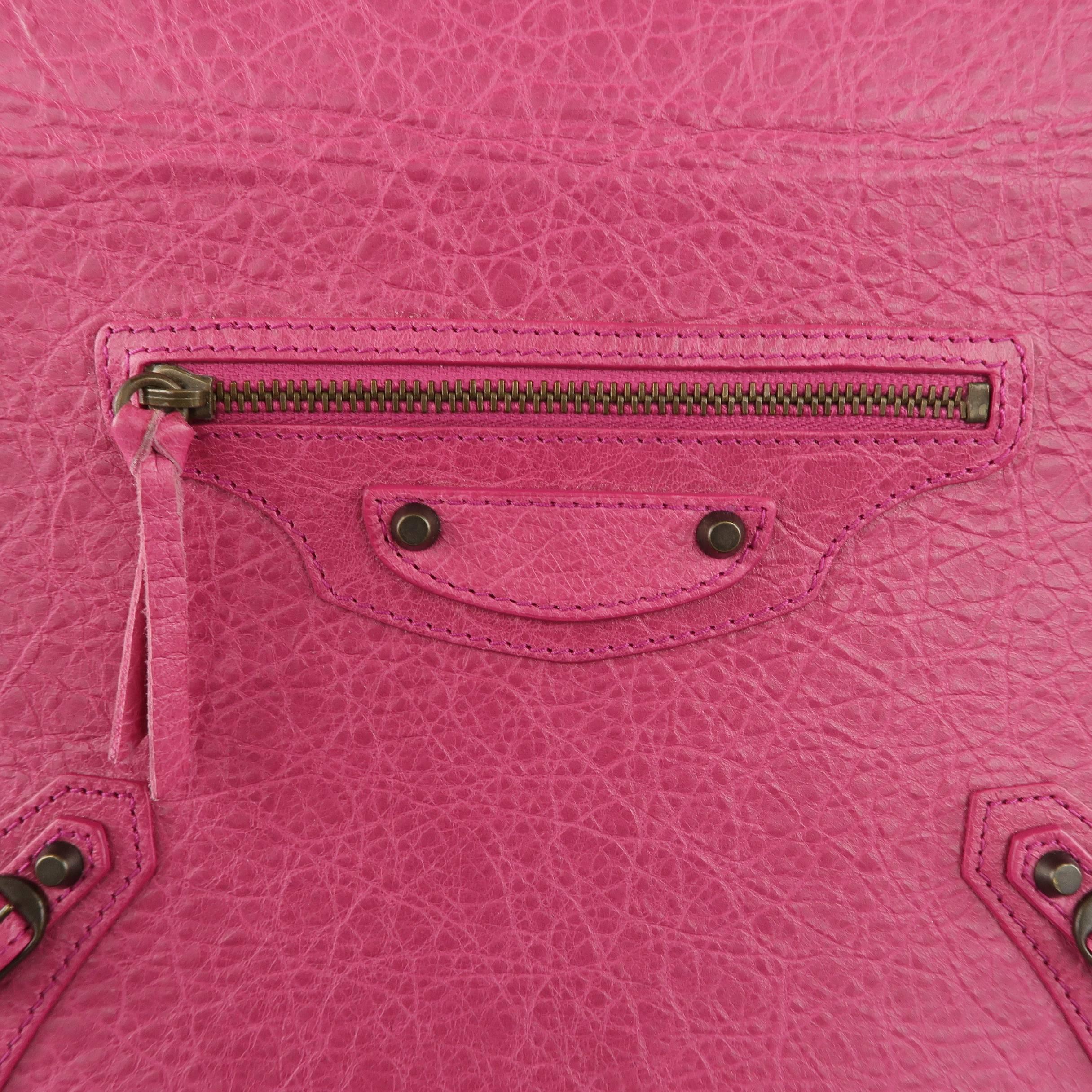 BALENCIAGA ipad 2 stand case comes in dark fuchsia pink textured leather and features signature moto detailed front with dark antique gold hardware and studs. Minor wear. With box. Made in Italy.
 
Good Pre-Owned Condition.
 
Measurements:
 
9.5 x