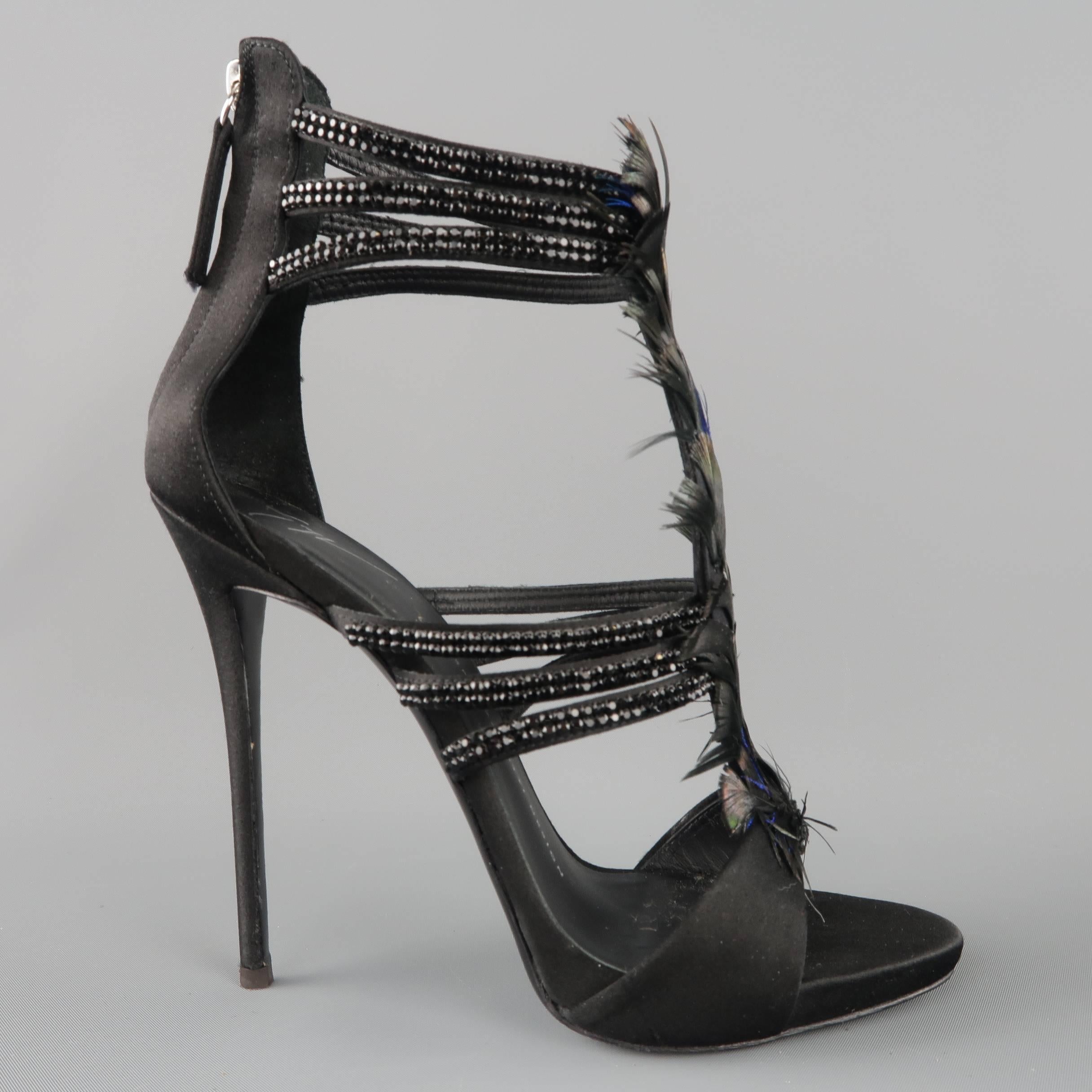 GIUSEPPE ZANOTTI "Coline" sandals come in black silk satin and feature black rhinestone studded straps, covered stiletto heel, and peacock feather embellished T strap front. Made in Italy.
 
Excellent Pre-Owned Condition.
Marked: IT 38.5
