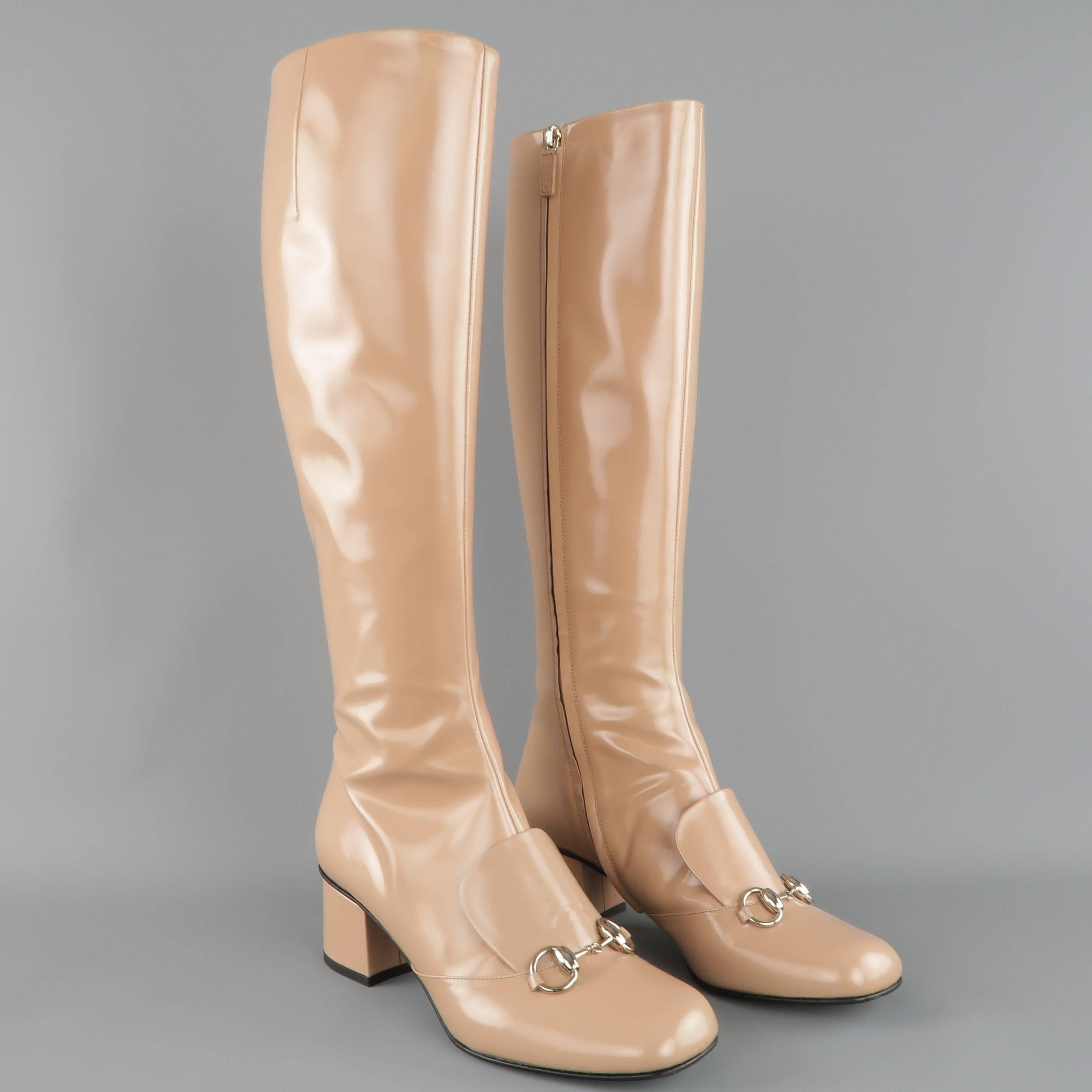 GUCCI "Lillian" knee high boots come in a tan glossy smooth leather and feature a round squared toe, silver tone horsebit hardware, mock loafer tongue, and covered chunky heel. Scuff on heel. As-Is. Made in Italy.
 
Good Pre-Owned