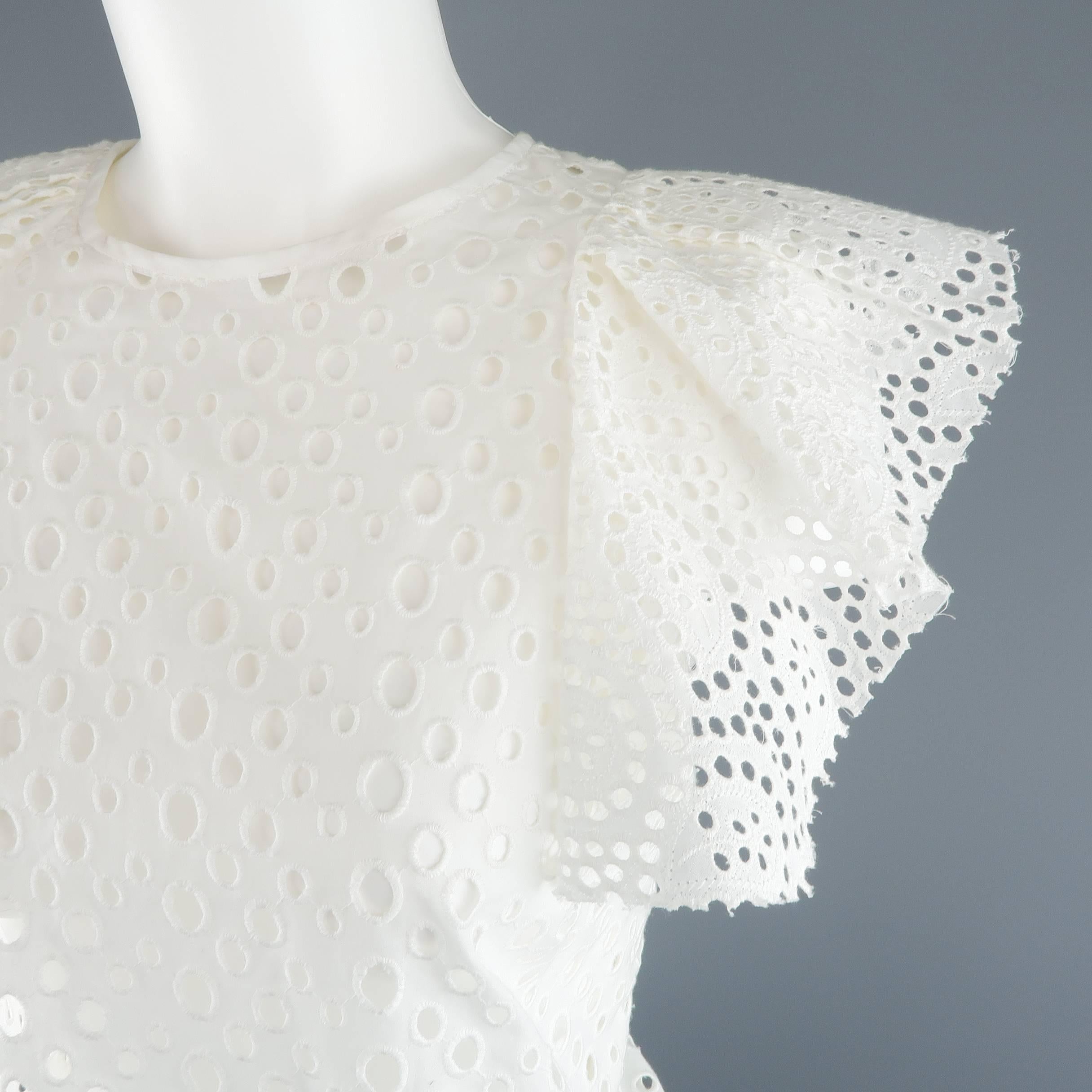 ISABEL MARANT spring top comes in a polka dot cut out perforated cotton lace and features an oversized silhouette, round neckline, and asymmetrical pleated ruffle sleeves. Made in Poland.
 
Excellent Pre-Owned Condition.
Marked: (no size)
