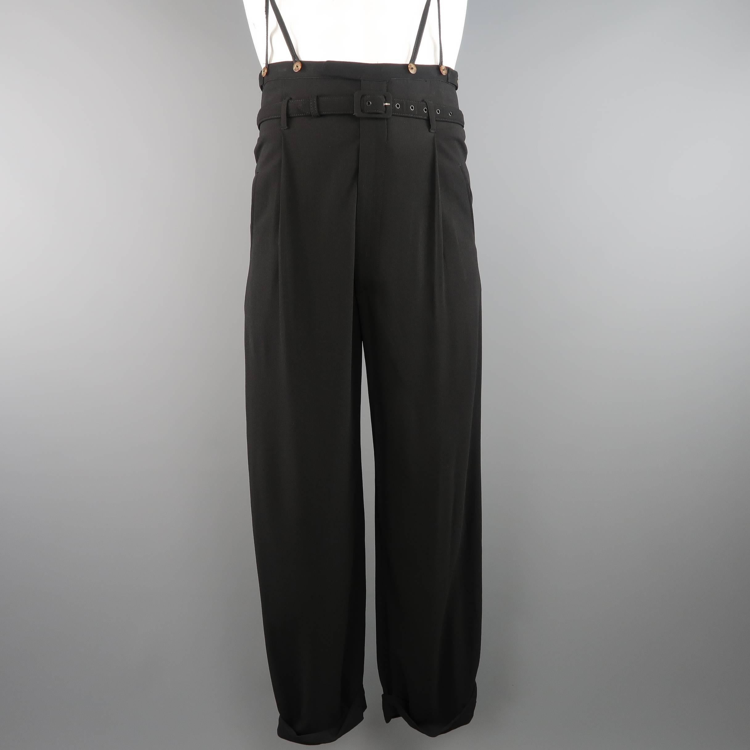 Archive JEAN PAUL GAULTIER HOMME 1930's style trousers come in a black wool crepe and feature an ultra high rise, single pleat front, wide tapered leg, hand rolled cuff, fabric belt, and detachable braces. Made in Italy.
 
Good Pre-Owned