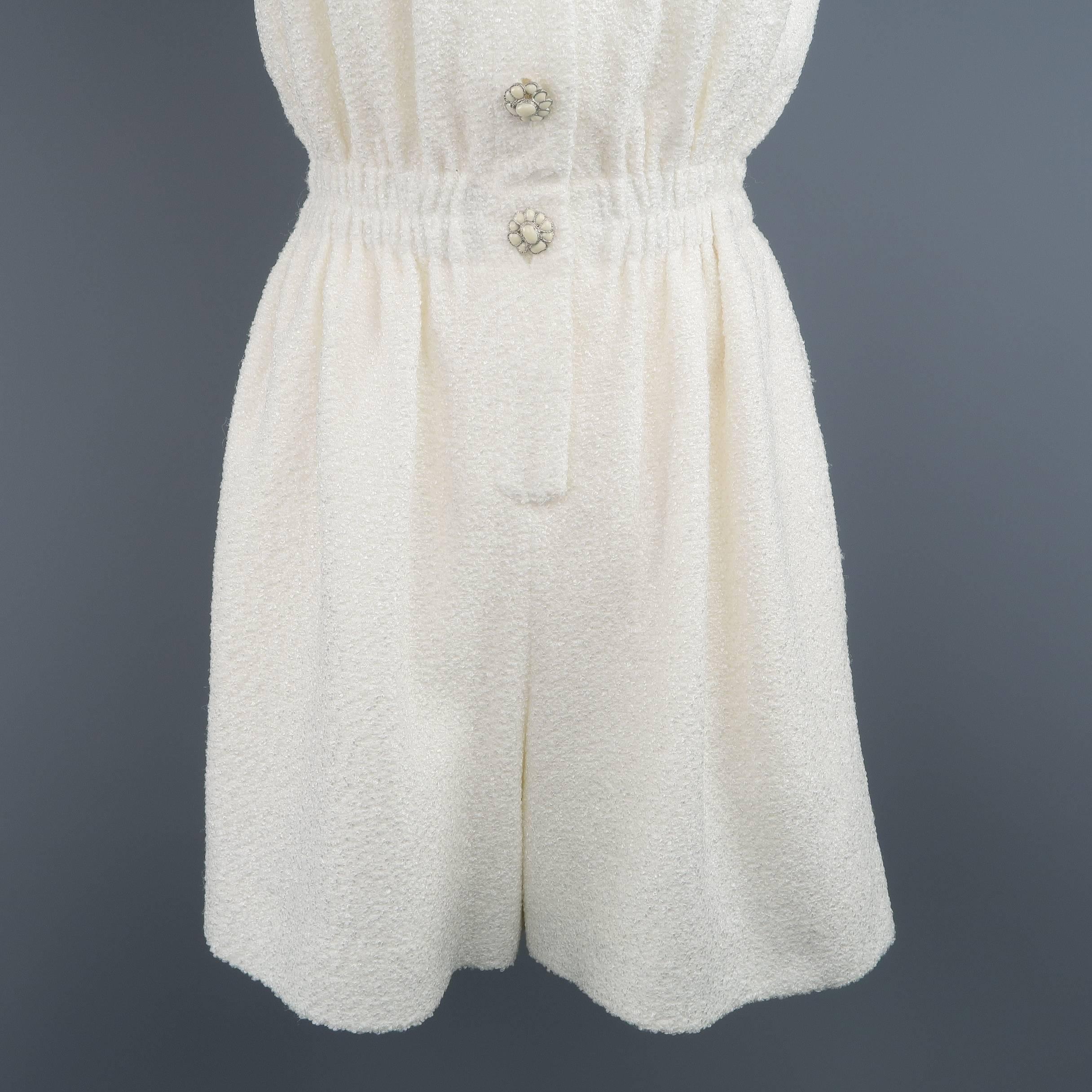 This gorgeous CHANEL romper comes in a creamy white textured fabric and features a round neckline, pleated bust, gathered waistband, and cream enamel flower buttons. Made in France.
 
Excellent Pre-Owned Condition.
Marked: EU 34
 
Measurements:
