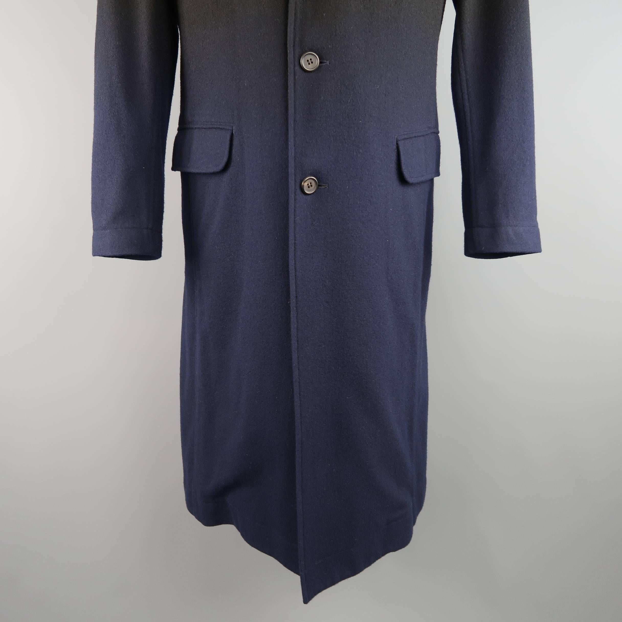 Archive ISSEY MIYAKE overcoat comes in a black wool blend and features a notch lapel, three button front, flap pockets, and overall navy blue ombre gradient effect throughout. Includes original tag. Made in Japan.
 
Good Pre-Owned Condition.
Marked: