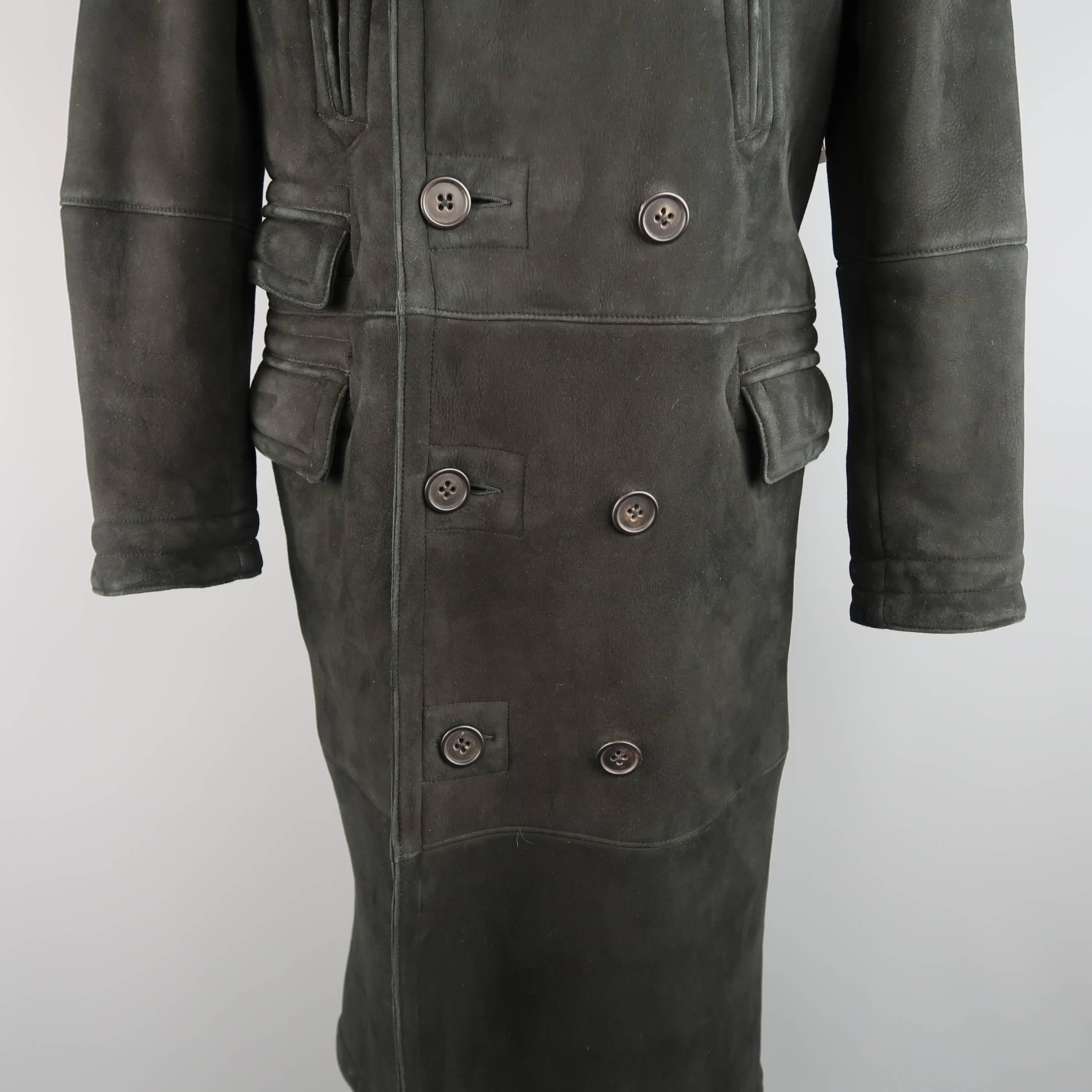 This full length POLO RALPH LAUREN pea coat comes in black Italian shearling and features a pointed fur lapel, double breasted button up front, slanted slit pockets, triple flap pockets, and full shearling fur interior. Wear throughout. As-Is.

