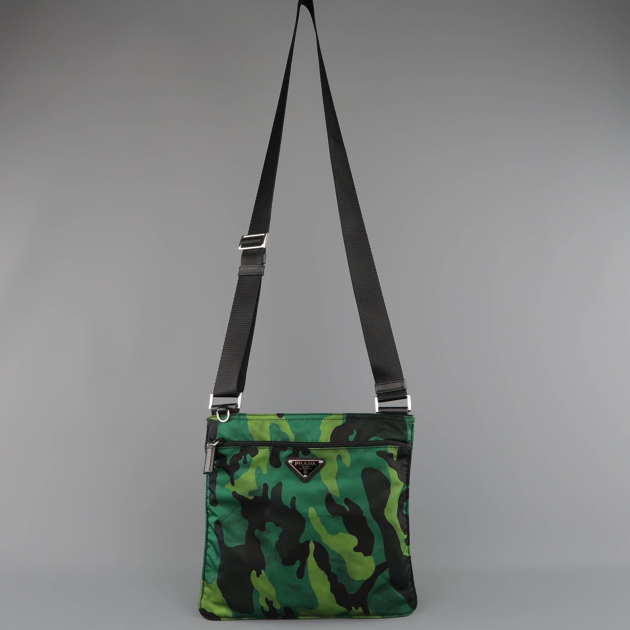 PRADA Tessuto crossbody bag comes in green and black distressed camouflage print nylon in a small square shape with double zip compartments with Saffiano leather trim, enamel logo plaque, and adjustable webbing crossbody strap. Little to no wear.